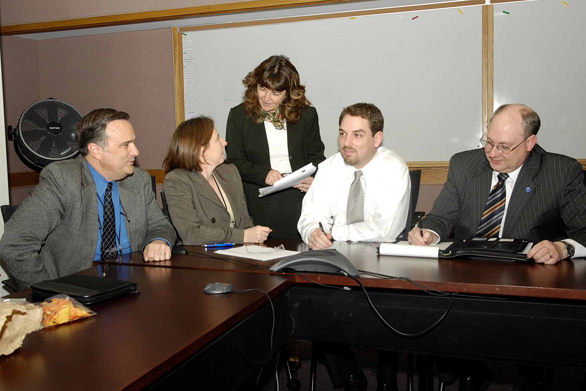 HANSCOM AFB, Mass. - Several members of an Electronic Systems Center team that’s focused on enhancing civilian recruiting efforts confer during a team meeting Wednesday.  Members seen here include (from left): Larry Coe, vice director of the 551st Electronic Systems Wing, Dr. Susan Arnold of the 554 ELSW, Deputy Personnel Director Sherry Farley, Adam Correau of Contracting, and Jim McMath of ESC’s Capabilities Integration Office. (U.S. Air Force photo by Linda LaBonte Britt)

