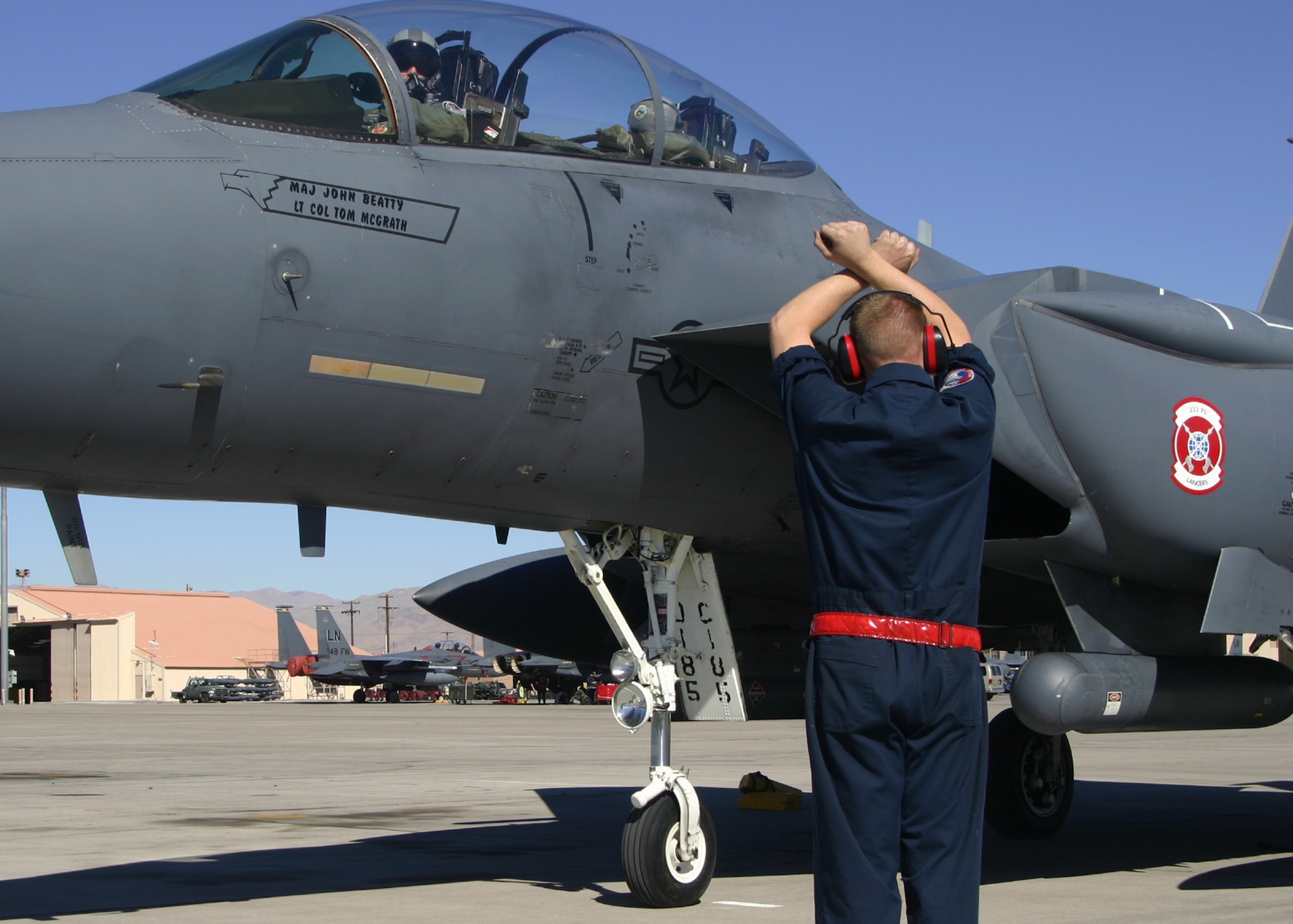 NELLIS AIR FORCE BASE, NEV - A crew chief from the 333rd Fighter Squadron marshalls in an F-15E Strike Eagle, February 7, 2008. (U.S. Air Force photo by Staff Sgt. Darin Moulton)