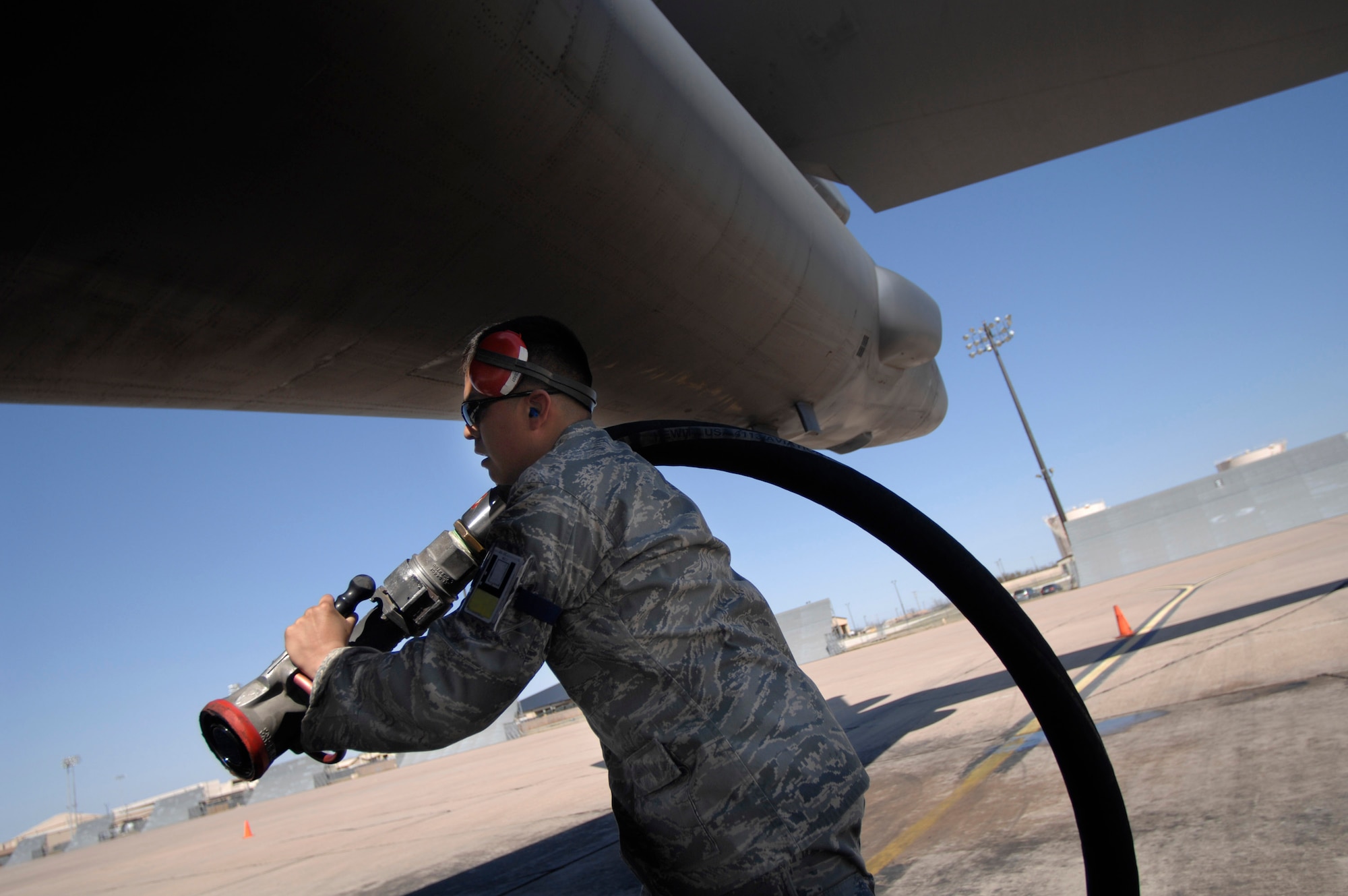 Airman Jesus Abalos pulls out a hose to inject fuel into a B-1B Lancer March 19 at Dyess Air Force Base, Texas. The bomber was the Air Force's first aircraft to fly at the supersonic speeds using a 50/50 blend of synthetic and petroleum fuel. The supersonic flight occured over the White Sands Missile Range airspace in south-central New Mexico, but took off from Dyess AFB. Airman Abalos is a fuels distribution specialist with the 7th Logistics Readiness Squadron. (U.S. Air Force photo/Tech. Sgt. Cecilio M. Ricardo)