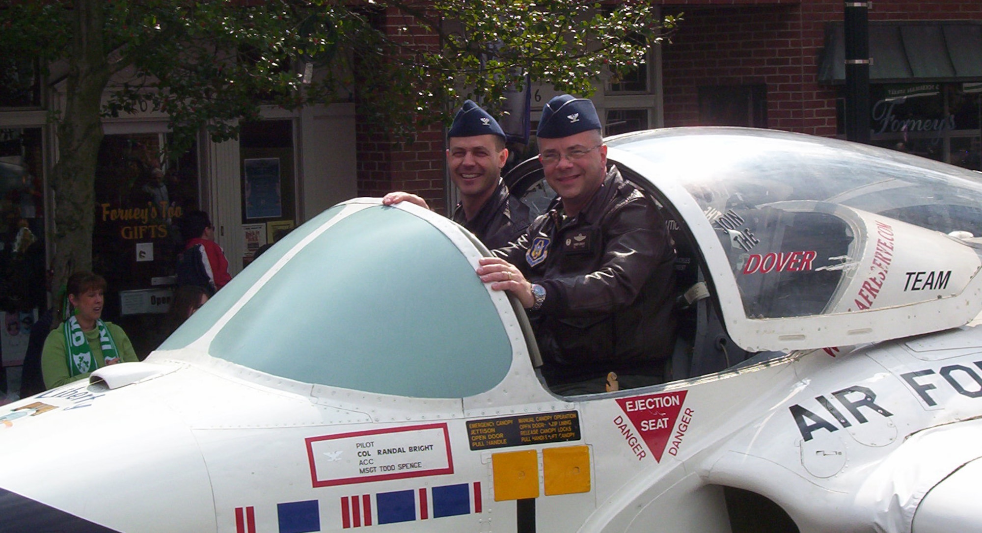 (Left) Col. Steve Harrison, 436th Airlift Wing commander and Col. Randy Bright, 512th AW commander, greeted the crowd on Dover’s Loockerman Street March 15 during the 15th Annual St. Patrick’s Day Parade from the cockpit of the T-37 Liberty Belle aircraft. (U.S. Air Force photo/ Susan Walls)