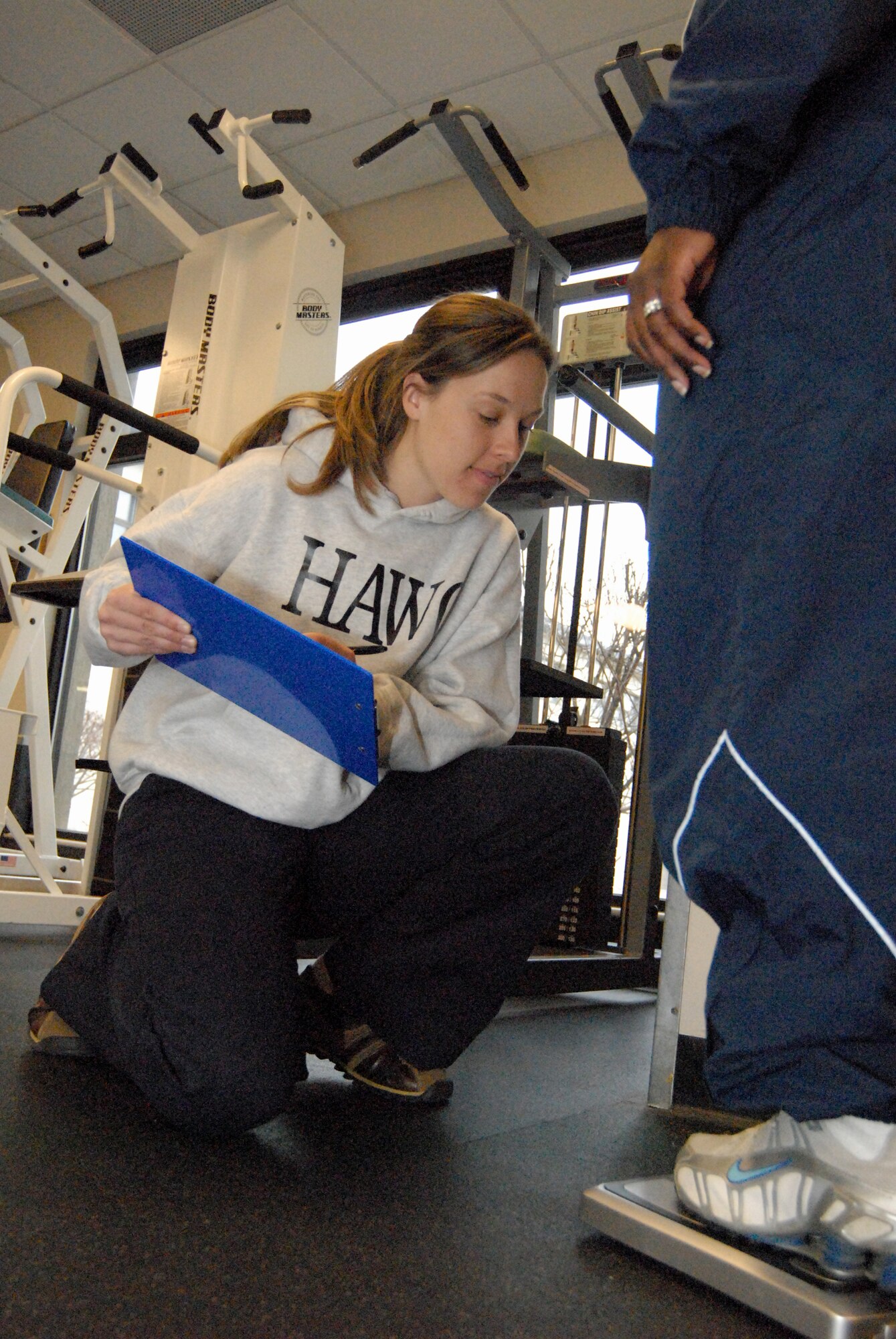 Nicole Voyer, 436th Aerospace Medicine Squadron HAWC health education program manager, measures a participant’s weight at the Fitness Center. (U.S. Air Force photo/ Airman 1st Class Shen-Chia Chu)