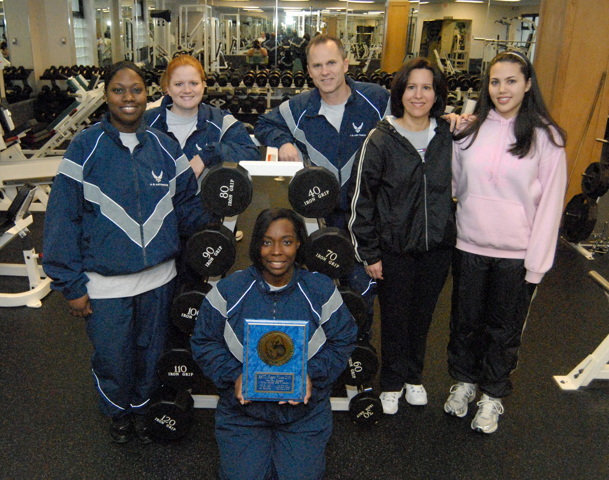 The ‘Shanghai Knights,’ from the 436th Logistics Readiness Squadron, recently won the Biggest Winner contest. The winners are (left to right) Staff Sgt. Jessica Sera, Staff Sgt. Khalinda Rose, Tech. Sgt. Felicia Williams and Chief Master Sgt. Gary Webb with his wife Janet and daughter Ryan. The team won first place by losing 124.2 pounds in nine weeks. (U.S. Air Force photo/ Airman 1st Class Shen-Chia Chu)