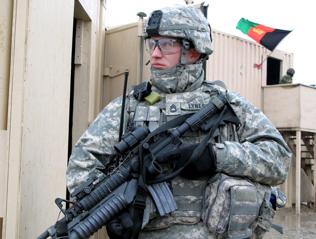 Army Sgt. 1st Class Micah S. Lyness, a New York State National Guardsman, stands watch in a simulated Afghan village at Fort Riley, Kan., March 17, 2008. The village is used to train U.S. military advisors en route for duty in Afghanistan or Iraq. 