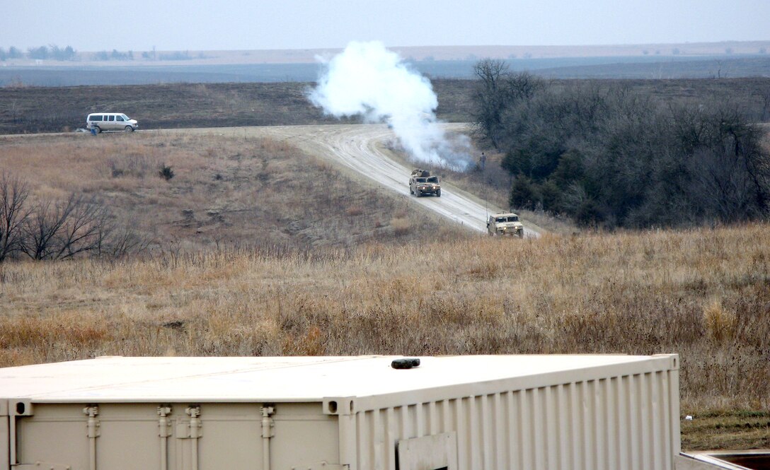 A convoy of U.S. and Afghan soldiers is attacked by insurgents as it heads toward a simulated Afghan village during U.S. military advisor training at Fort Riley, Kan., March 17, 2008. Several such “villages” used for Iraq and Afghanistan training exercises are scattered across Fort Riley’s 100,000 acres. 
