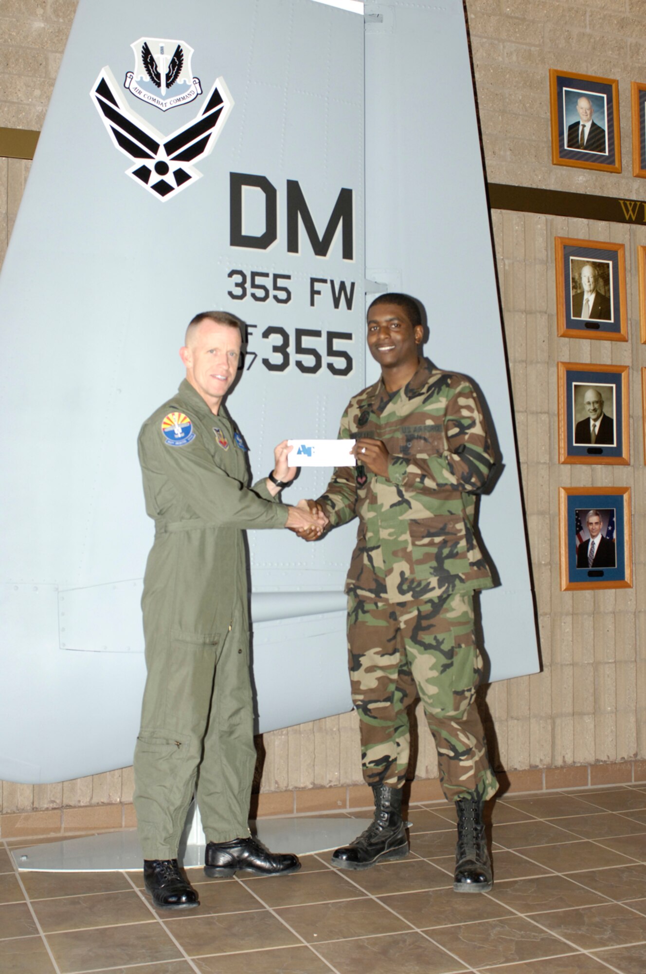 355th Fighter Wing Commander Col. Kent Laughbaum presents Davis-Monthan's Air Force Assistance Fund project officer 2nd Lt. Michael Hargett with his contribution form March 14 at the Leo K. Thorsness headquarters building. 

"The Air Force Assistance Fund is what being a good wingman is all about," the Colonel said, reflecting on the program's purpose of helping Airmen to take care of their fellow Airmen in times of need. (U.S. Air Force Photo By Master Sgt. Jim Fisher)