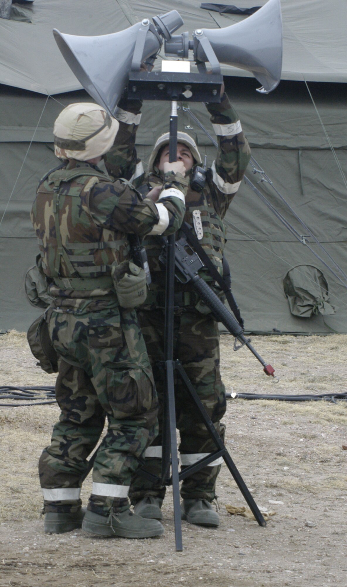 Tech. Sgt. Jonathan Mills and Senior Airman Jonathan Farwell, both from the 90th Communications Squadron, assemble two loudspeakers at the base training field  March 13. These speakers, and others like it, help broadcast messages from the Giant Voice. The Giant Voice warns Airmen of imminent ground and missile attacks and announces important instructions (U.S. Air Force photo/2nd Lt. Lisa Meiman)