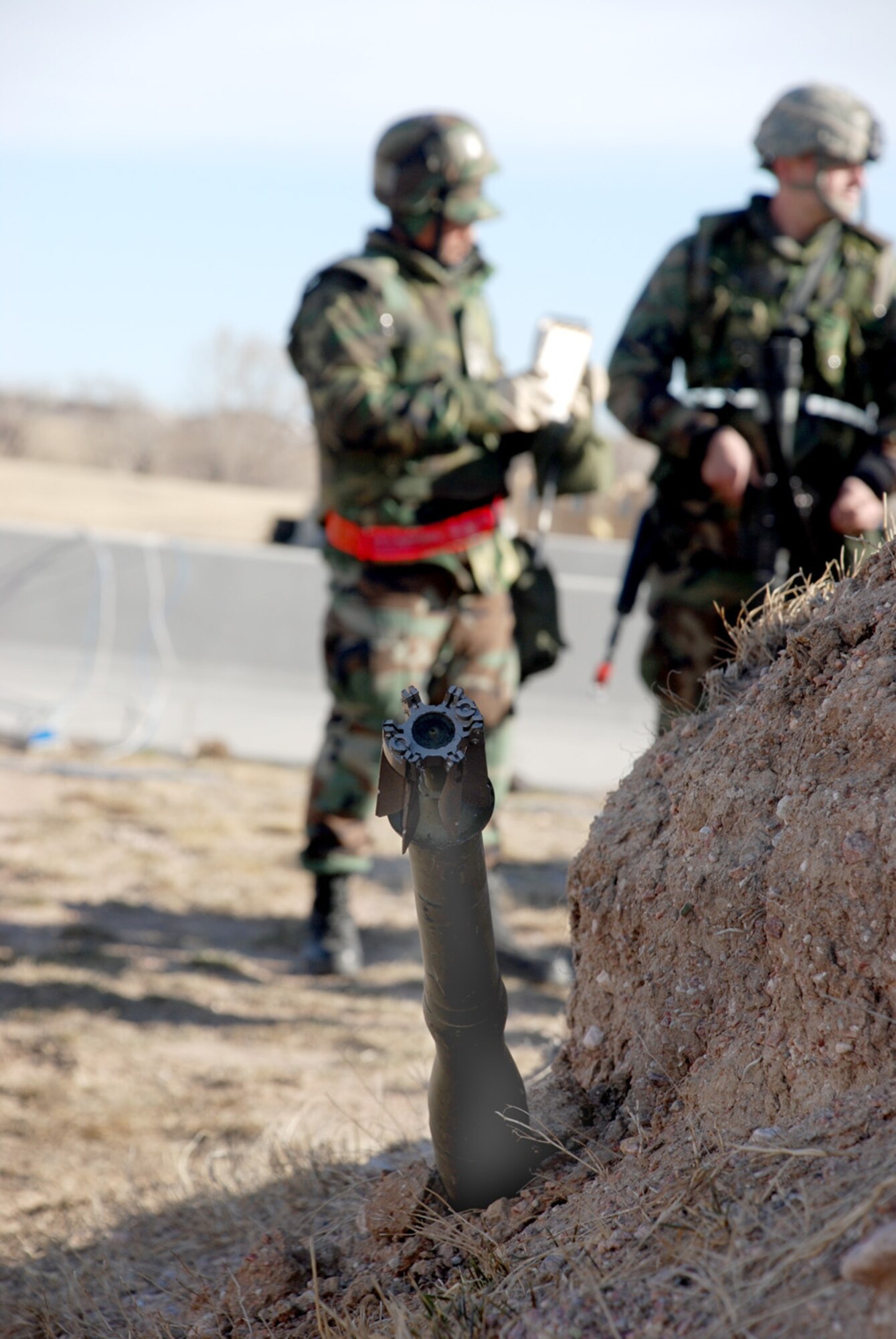 Airman 1st Class Jonathan Ravana, 90th Civil Engineer Squadron, explains the procedures for marking an unexploded ordnance to his group during a training exercise at the base training field March 13. After Airman Ravana saw the UXO, he used a checklist to identify all the proper steps (U.S. Air Force photo/A1C Daryl Knee).