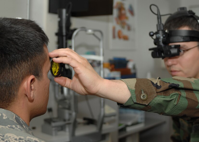 DYESS AIR FORCE BASE, Texas -- Captain John Allen, Optometrist, uses a phoropter  on a patient, March 18. A phoropter is an istrument used to determine the true eye glass prescriptions for a patient. (U.S. Air Force photo by Senior Airman Courtney Richardson)