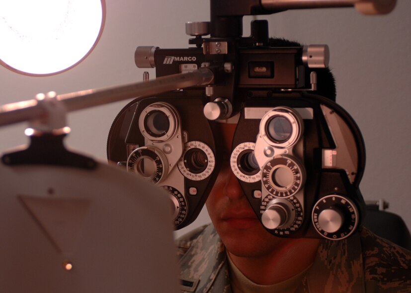 DYESS AIR FORCE BASE, Texas-- 1st Lieutenant Rudy Talamantez, 7th Logistics Readiness Squadron Installation Deployment Officer, conducts a refraction test, March 18. The refraction test is an eye exam that measures a person's ability to see an object at a specific distance. (U.S. Air Force photo by Senior Airman Courtney Richardson)