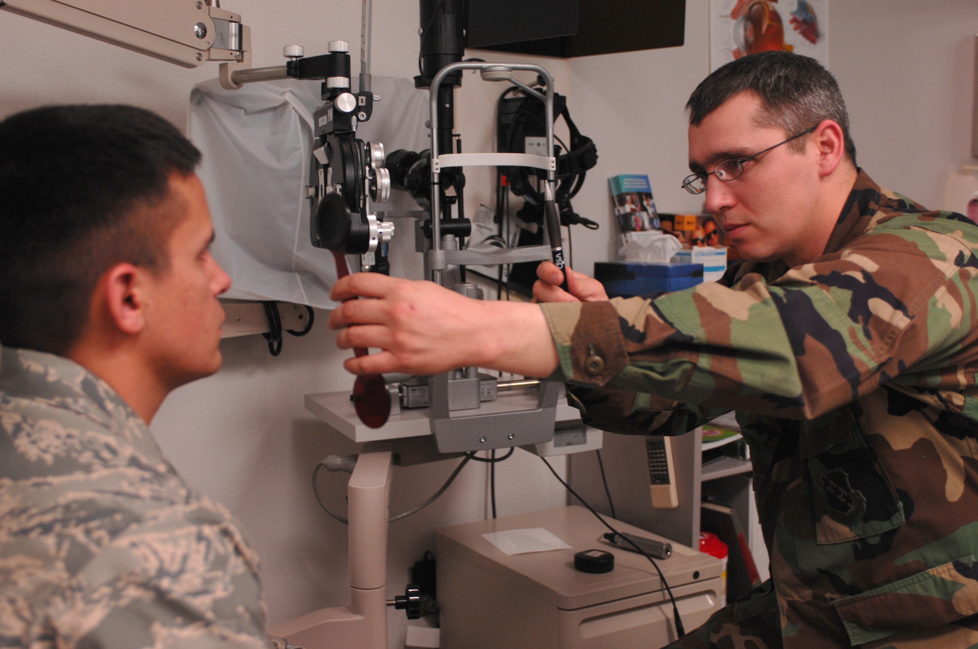 DYESS AIR FORCE BASE, Texas-- Captain John Allen, Optometrist, performs a cover test on 1st Lientenant Rudy Talamantez, March 18. A cover test checks for the alignment of the patient's eyes and determines how wide a persons vision range is. (U.S. Air Force photo by Senior Airman Courtney Richardson)