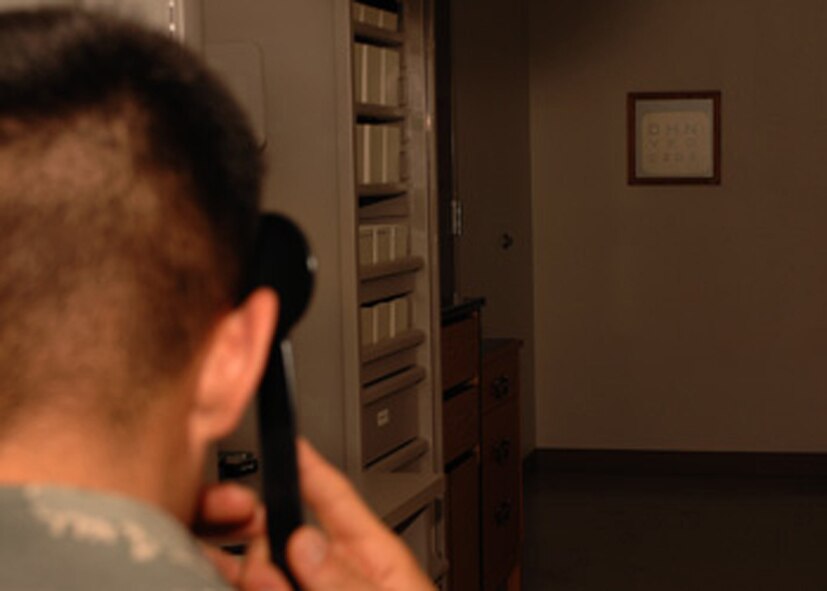 DYESS AIR FORCE BASE, Texas -- 1st Lieutenant Rudy Talamantez, 7 Logistics Readiness Squadron Installation Deployment Officer, performs a visual acuity test, March 18. A visual acuity test determines the clarity of a persons vision and helps determine what type of prescription is needed. (U.S. Air Force photo by Senior Airman Courtney Richardson)