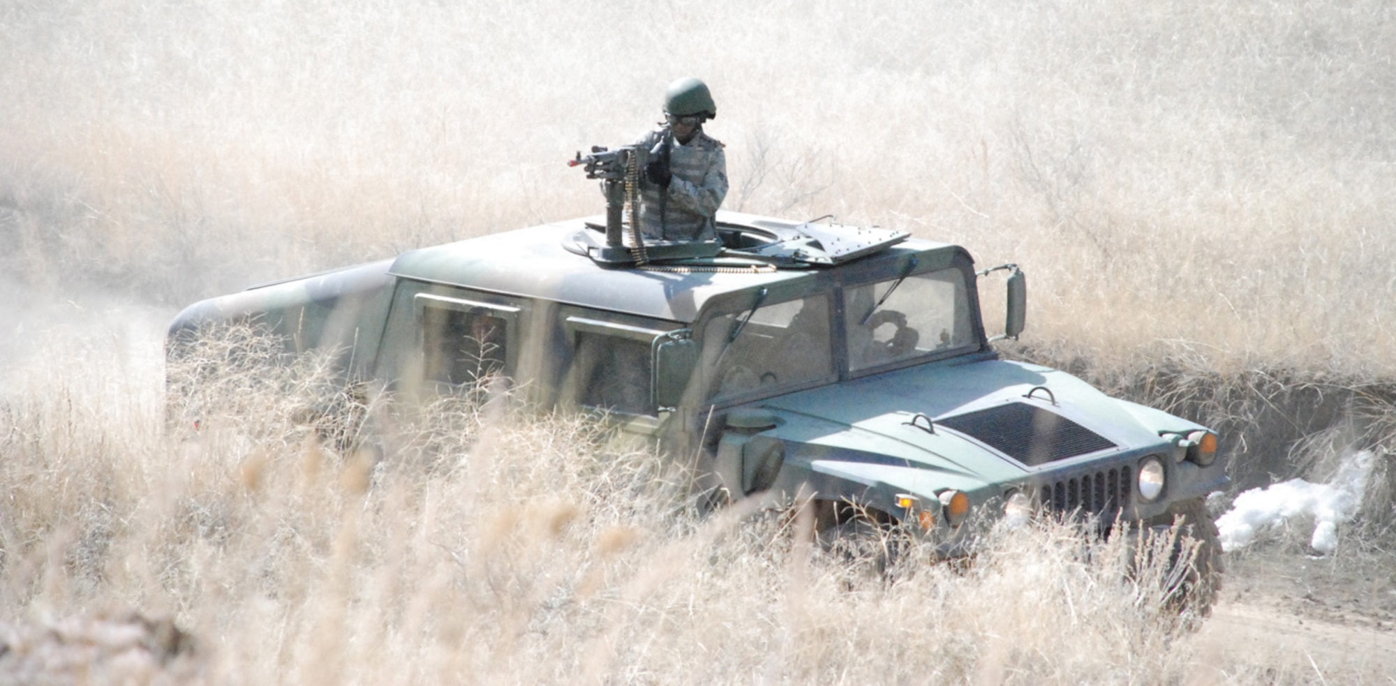 An RTC student shoots at opposing forces equipped with mock weapons and ground burst simulators. The students tested on correct applications of procedures learned in the classroom before the exercise. Along with convoy training, students also learned air base defense tactics and close-quarters combat.