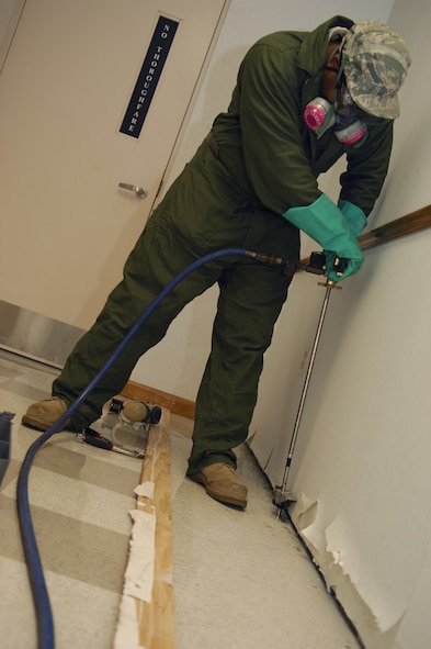 MOODY AIR FORCE BASE, Ga. -- Staff Sgt. Richard Mauldin, 23rd Civil Engineer Squadron environmental control craftsman, injects a termite insecticide called Termidor into drilled holes here March 18. The base entomology flight is notified by organizations with pest problems and works to correct them. (U.S. Air Force photo by Senior Airman Elizabeth Rissmiller)