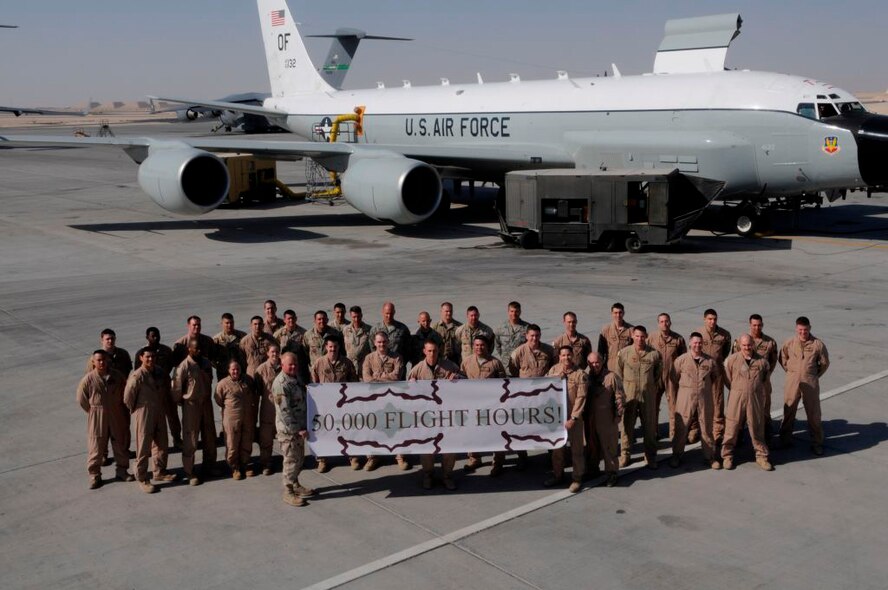 Deployed members of the 55th Wing pose for a celebratory photo following their Rivet Joint aircraft surpassing the 50,000 flying-hour mark.