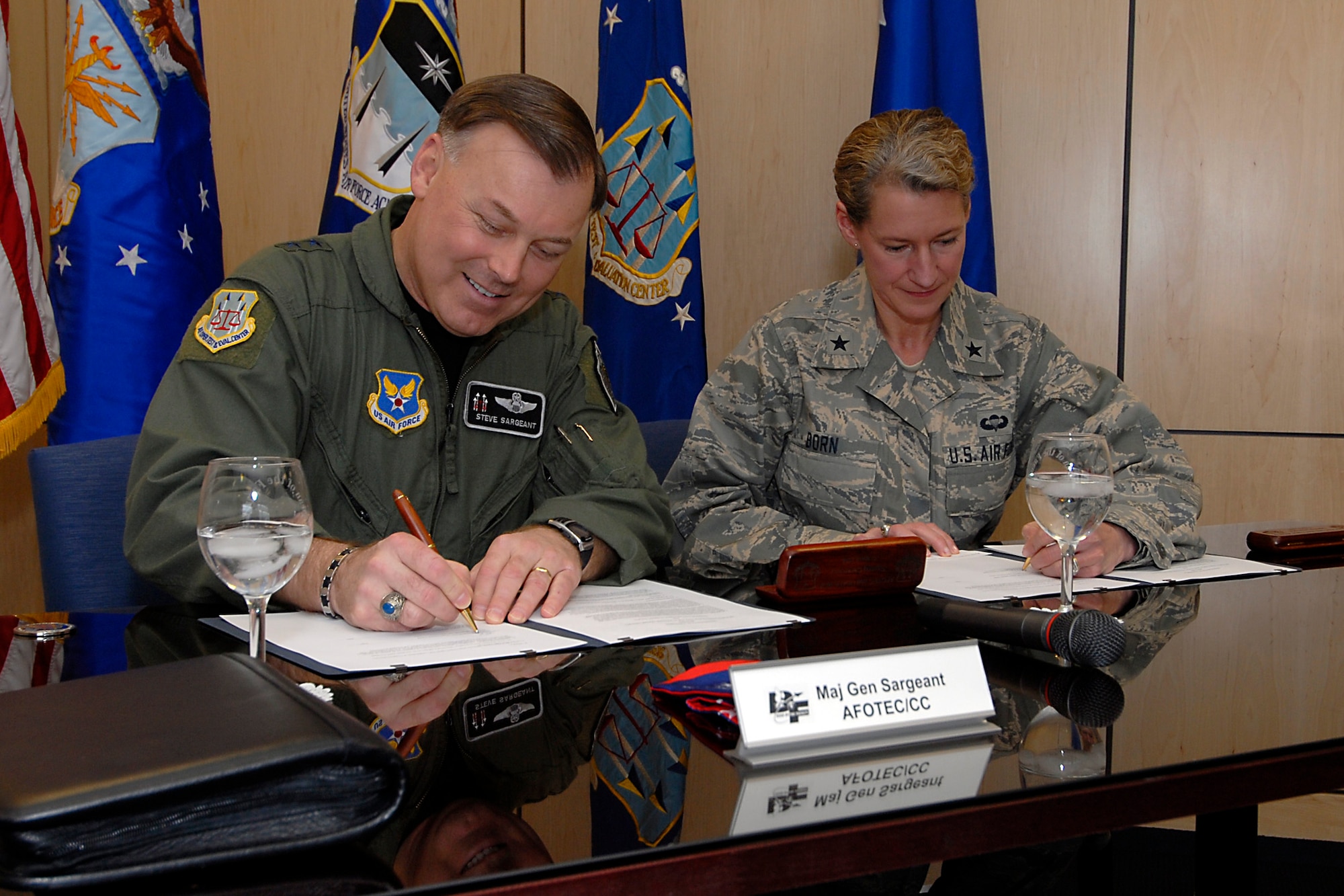 (From left) Maj. Gen. Stephen T. Sargeant, Air Force Operational Test and Evaluation Center Commander and Brig. Gen. Dana Born, U.S. Air Force Academy Dean of Faculty, sign a memorandum of agreement creating a mentoring program between AFOTEC and the USAFA during a formal signing ceremony at the Academy in Colorado Springs, Colo., on March 17, 2008.