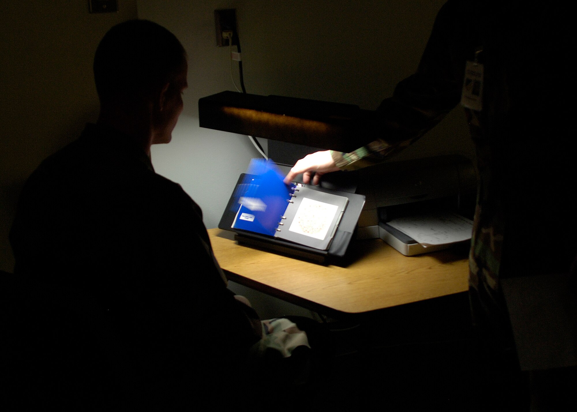 Senior Airman Anthony Hayner, 49th Aeromedical-Dental Squadron ophthalmic technician performs a color vision test for Staff Sgt. Gregory Fentress, 49th Communications Squadron ground radar systems craftsman, at Holloman Air Force Base, N.M., on March 20, 2008. (U.S. Air Force photo/Airman 1st Class Michael Means)