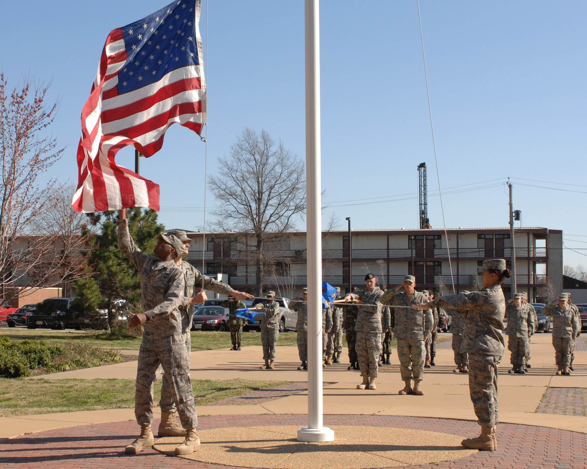 LANGLEY AIR FORCE BASE, Va.--Senior Airman Tatchy Kragbe from the 1st Civil Engineer Squadron,  catches the American flag while Staff Sgt. William Beasley,  10th Intelligence Squadron and Senior Airman Jamie Dixon, 1st Fighter Wing lower it during a Formal Retreat Ceremony preformed by Airmen Leadership School Class 08-C March 20. (U.S.  Air Force photo/Tech. Sgt. Wickes)