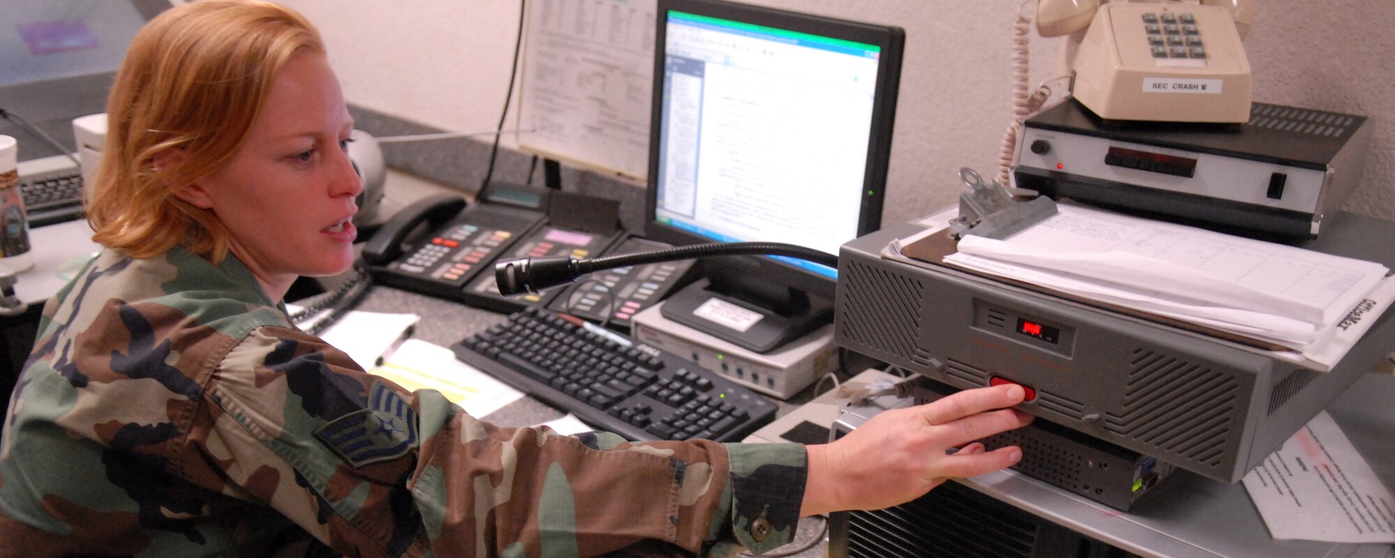 Staff Sgt. Dawn Merzak, 56th Security Forces trainer, mans the Base security operations control center, Mar. 18. Her job is to monitor all facility alarm notifications, dispatch units to reported incidents and is the eyes and ears of base security. SSgt Merzak’s main goal is to provide second to none security to Luke Air Force Base. (U.S. Air Force photo/Airman 1st Class Gustavo Gonzalez) 