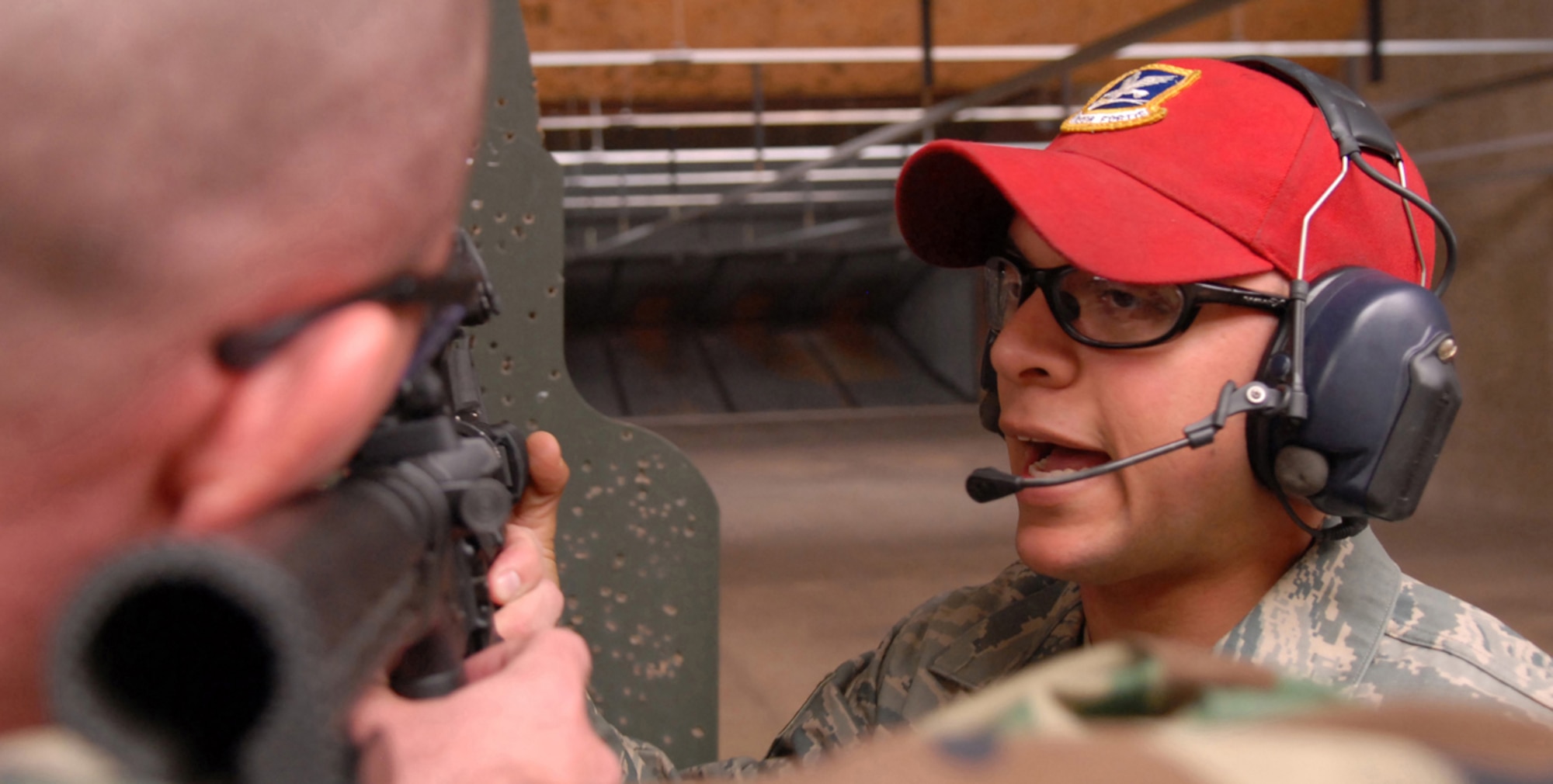 Staff Sgt. Daniel Romero, 56th Security Forces Squadron combat arms instructor, instructs Maj. Brock Nolan, 56th Medical Operations Squadron staff therapist with techniques on how to fire an M-16 rifle, Mar. 18. SSgt Romero is responsible for maintaining and inspecting all weapons assigned to Luke Air Force Base. Combat Arms instructors conduct live fire training for over 2,000 personnel a year, and use a priority system to ensure deployment requirements are met. (U.S. Air Force photo/Airman 1st Class Gustavo Gonzalez)    