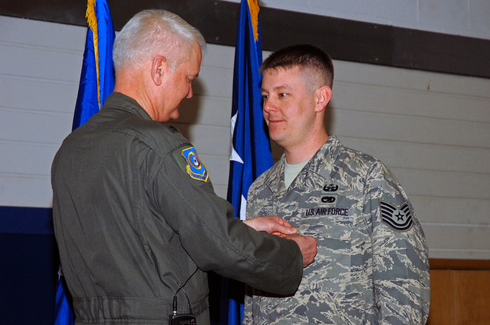 Lt. Gen. Robert D. Bishop Jr., 3rd Air Force commander, presents Tech. Sgt. Charles Price, 48th Civil Engineer Squadron, with a Bronze Star medal during an Airmen’s Call March 19 at RAF Lakenheath, England. Colonel Iverson earned the Bronze Star for efforts supporting Operation Iraqi Freedom. (U.S. Air Force photo by Airman Perry Aston)