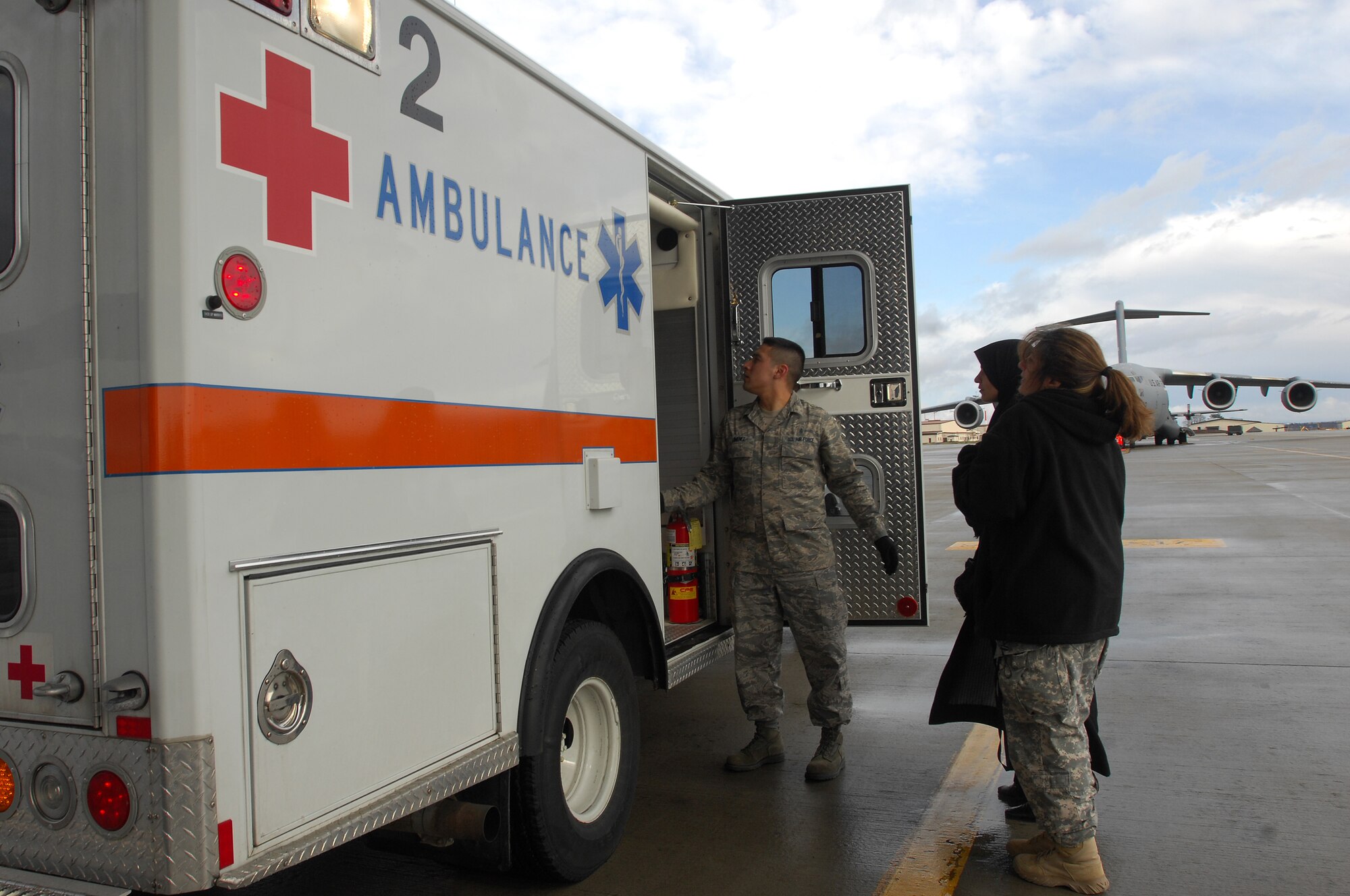 The mother of a three-year-old Iraqi burn victim and her translator wait to board an ambulance at Ramstein March 21. The Iraqi child and his mother will continue on to the states where he will receive further treatment. Photo by Airman 1st Class Kenny Holston*