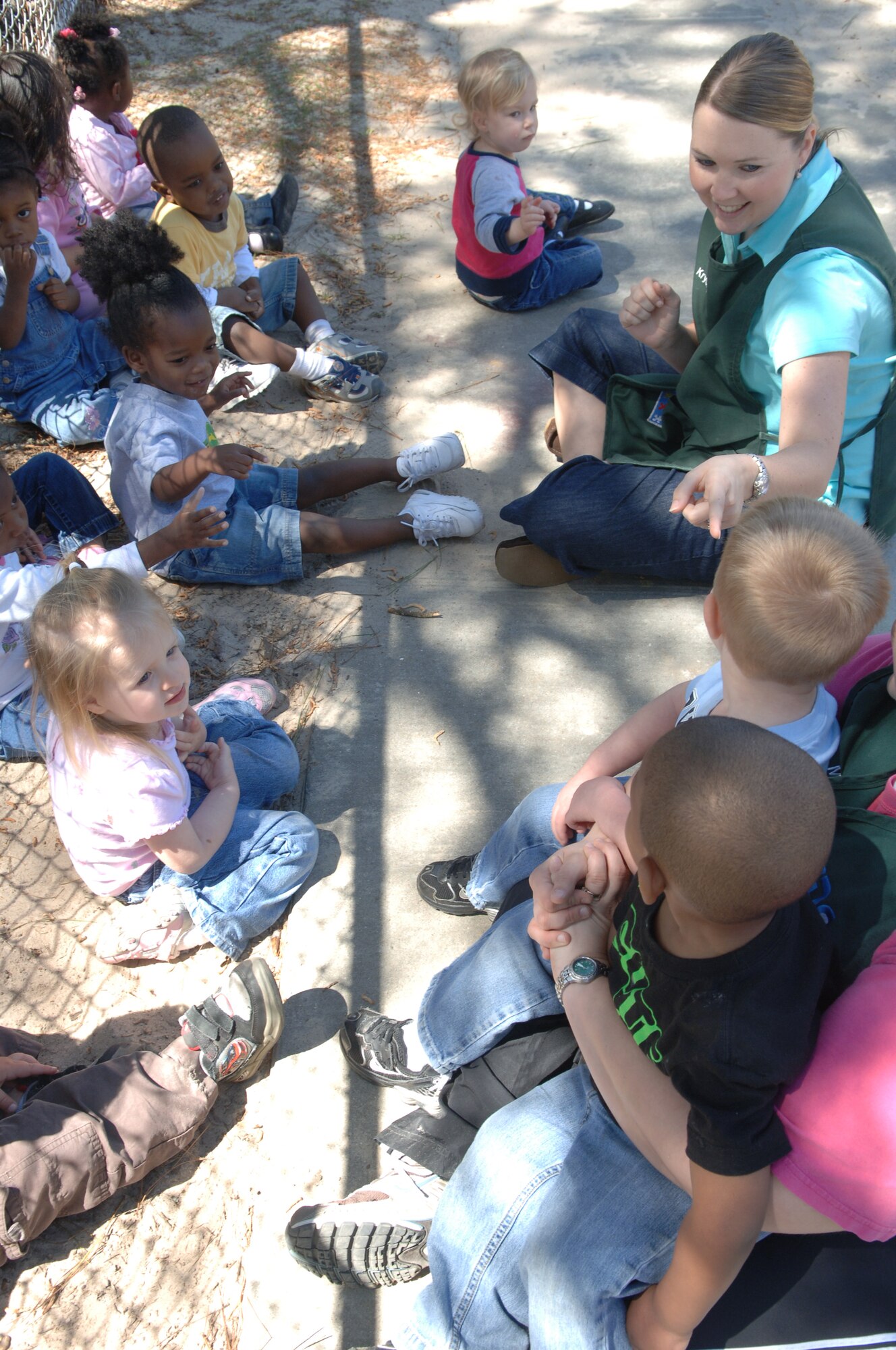 MOODY AIR FORCE BASE, Ga – Krystal Simmons, 23rd Wing Child Development Center child development program assistant, entertains the two-year old children while waiting to re-enter the building after a fire drill. The fire drills are monthly and unexpected, and all care givers most be able to react in a timely manner. (U.S. Air Force Photo by Senior Airman Schelli Jones)