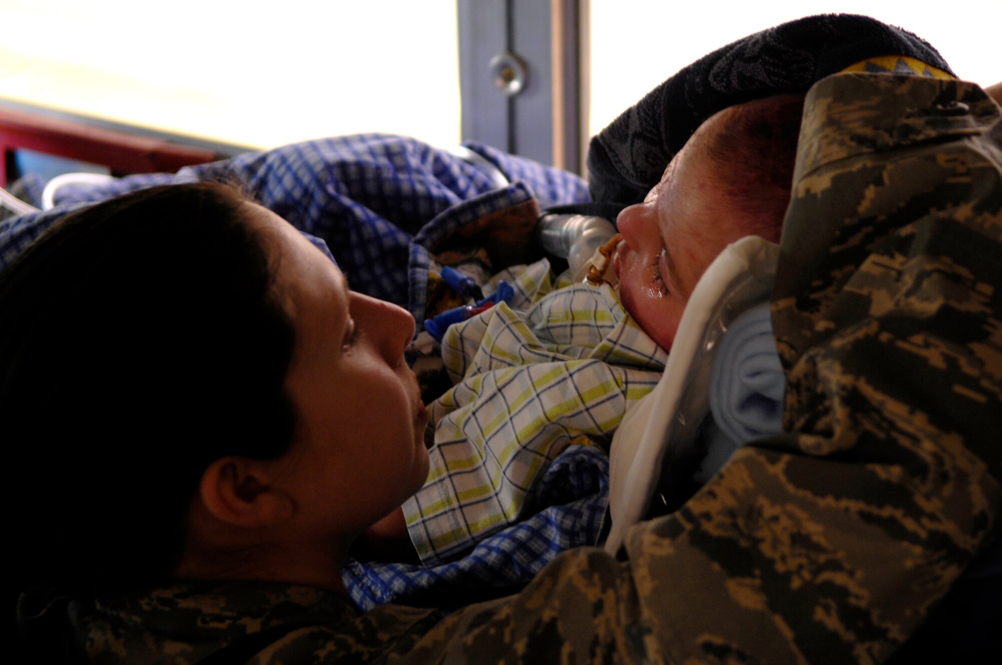 BALAD AIR  BASE, Iraq -- Capt. Konemann, 332nd Expeditionary Medical Squadron, says good-bye March 21 to Al Amreeki, a 3-year-old burn victim who has been in her care for two months at the Air Force Theater Hospital here. Al Amreeki was only given 48 hours to live after being burned in a fire.  Two months later he and his mother are being transported back to the United States for further treatment and physical therapy. U.S. Air Force Photo/Tech. Sgt. Jeffrey Allen 