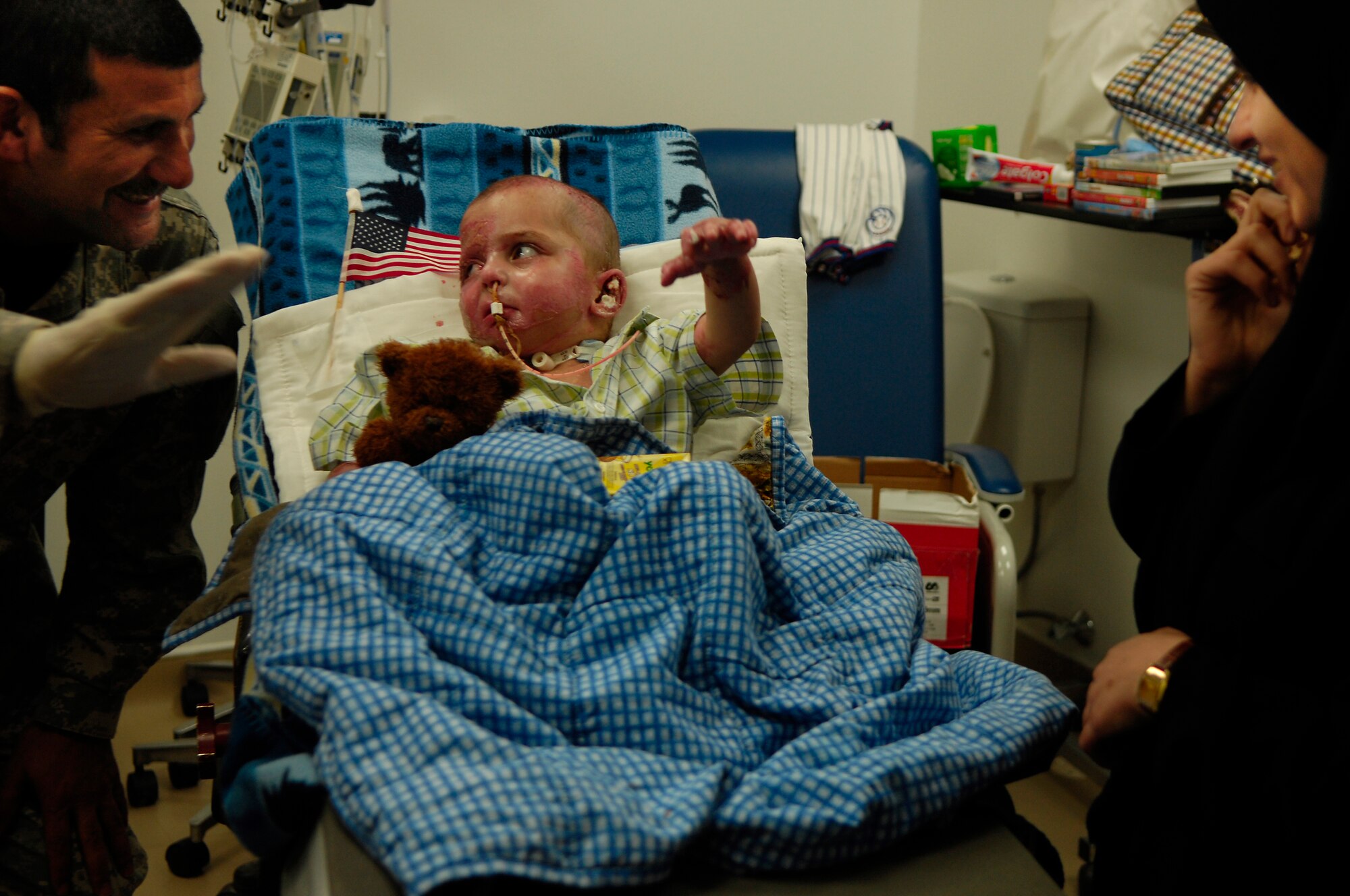 BALAD AIR BASE, Iraq -- Al Amreeki, a 3-year-old Iraqi burn victim waves good-bye before leaving on a medical evacuation flight from the Air Force Theater Hospital to the United States, March 21. Al Amreeki was only given 48 hours to live after being burned in a fire. Two months later he and his mother are being transported back to the United States for further treatment and physical therapy. (U.S. Air Force Photo/Tech. Sgt. Jeffrey Allen)