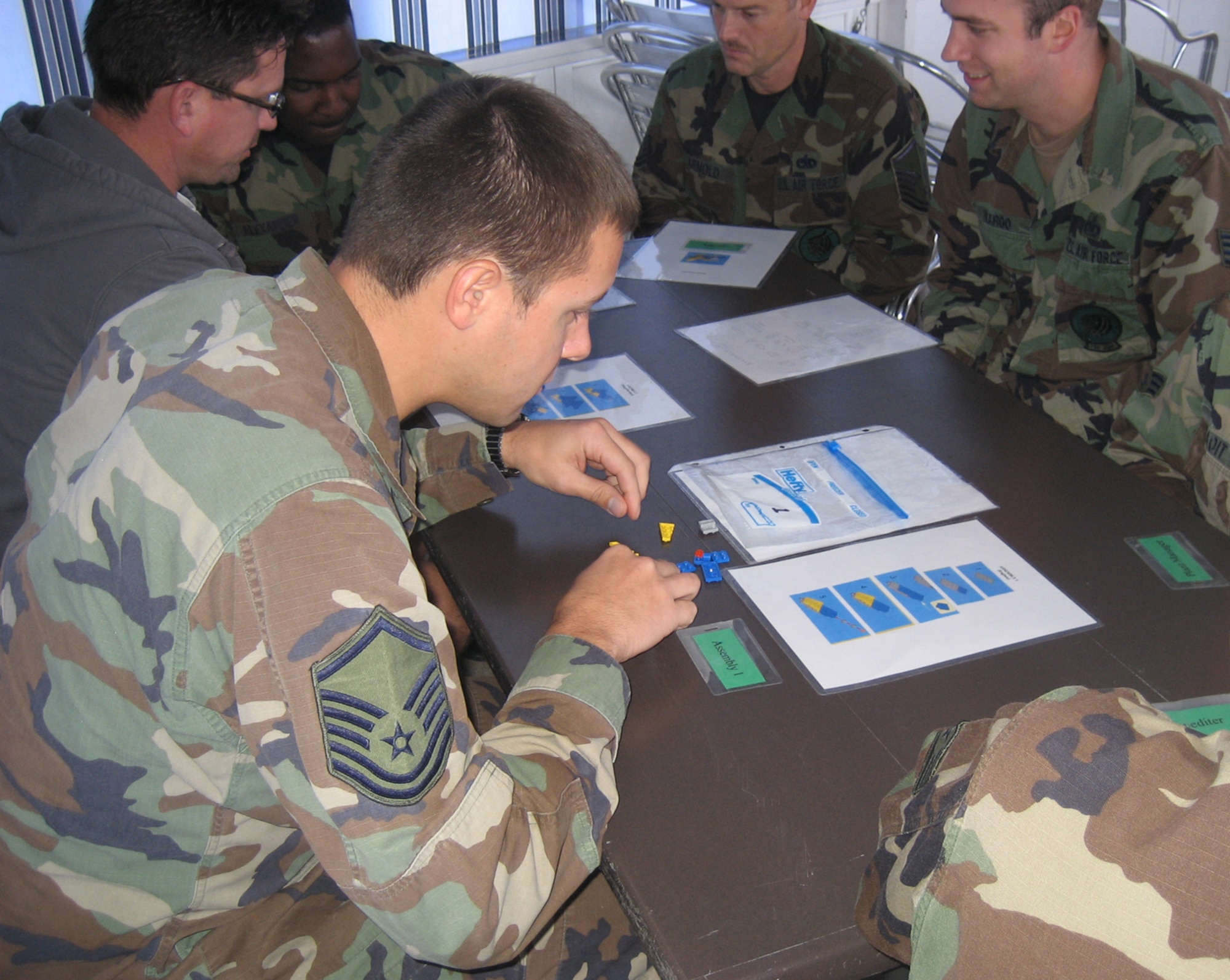 To learn Lean manufacturing concepts under the Air Force Smart Operations for the 21st Century, aircraft mechanics from the 725th Aircraft Maintenance Squadron, Rota Naval Air Station, Spain, build aeropod airplanes in an assembly line process. Senior Master Sgt. Bryan Ford, 512th Maintenance Group, Dover Air Force Base, assisted the overseas maintenance unit in implementing AFSO 21 principles by teaching them the AFSO 21 Phase 1 course. (U.S. Air Force photo/Senior Master Sgt. Bryan Ford)
