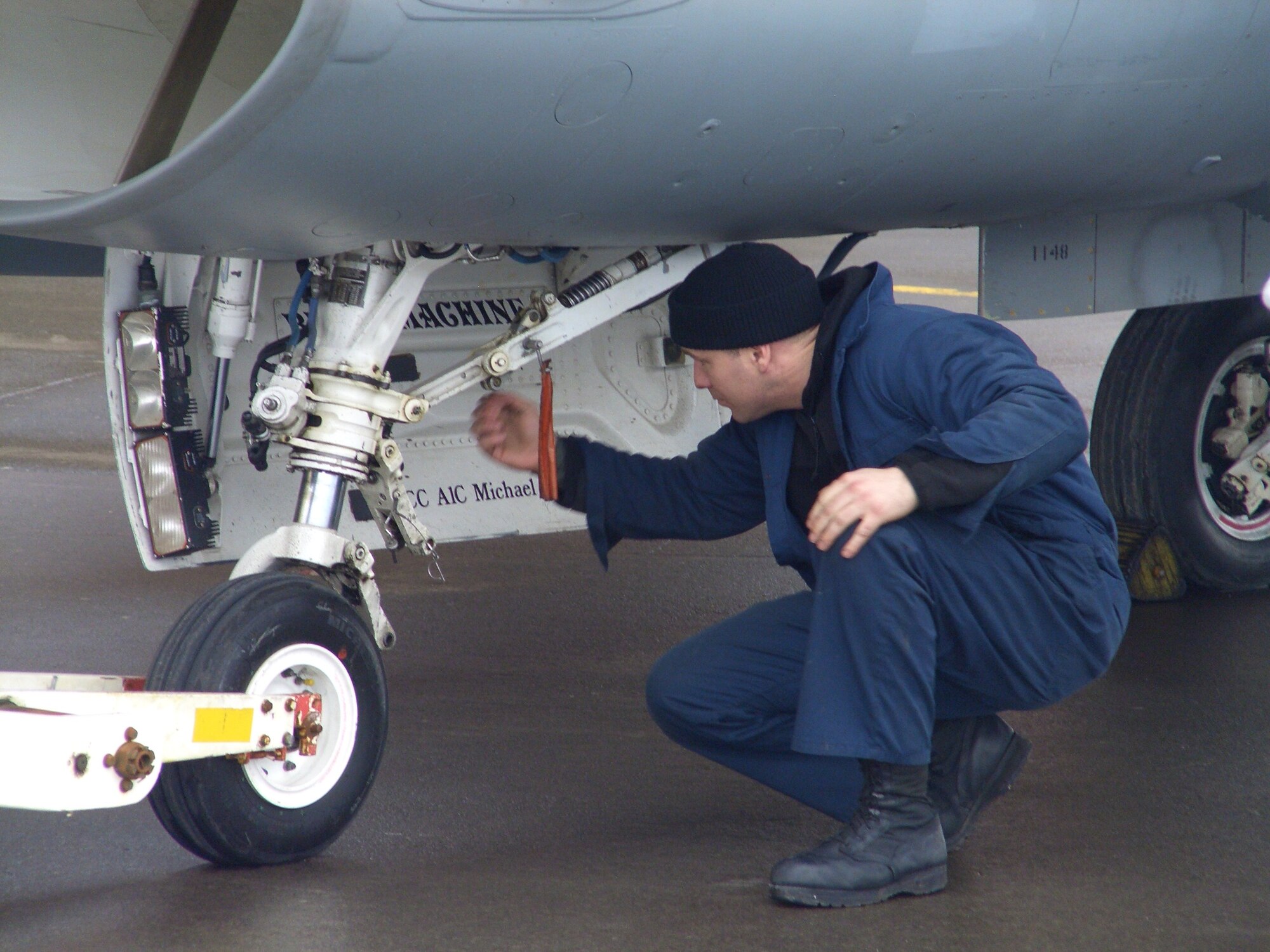 KEFLAVIK, Iceland – Staff Sgt. Lee Evertsen, 52nd Aircraft Maintenance Squadron, prepares an F-16 for towing after an operational check flight March 12, 2008. The Spangdahlem Airmen were in Keflavik, Iceland, to fix and fly back two diverted F-16s. (U.S. Air Force photo/Lt. Col. Tony Forkner)
