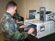 MINOT AIR FORCE BASE, N.D. -- Master Sgt. Jeremy Grotte, 5th Maintenance Group AFREP technician, fixes a power supply at the 5th Munitions Squadron here. (Courtesy photo)