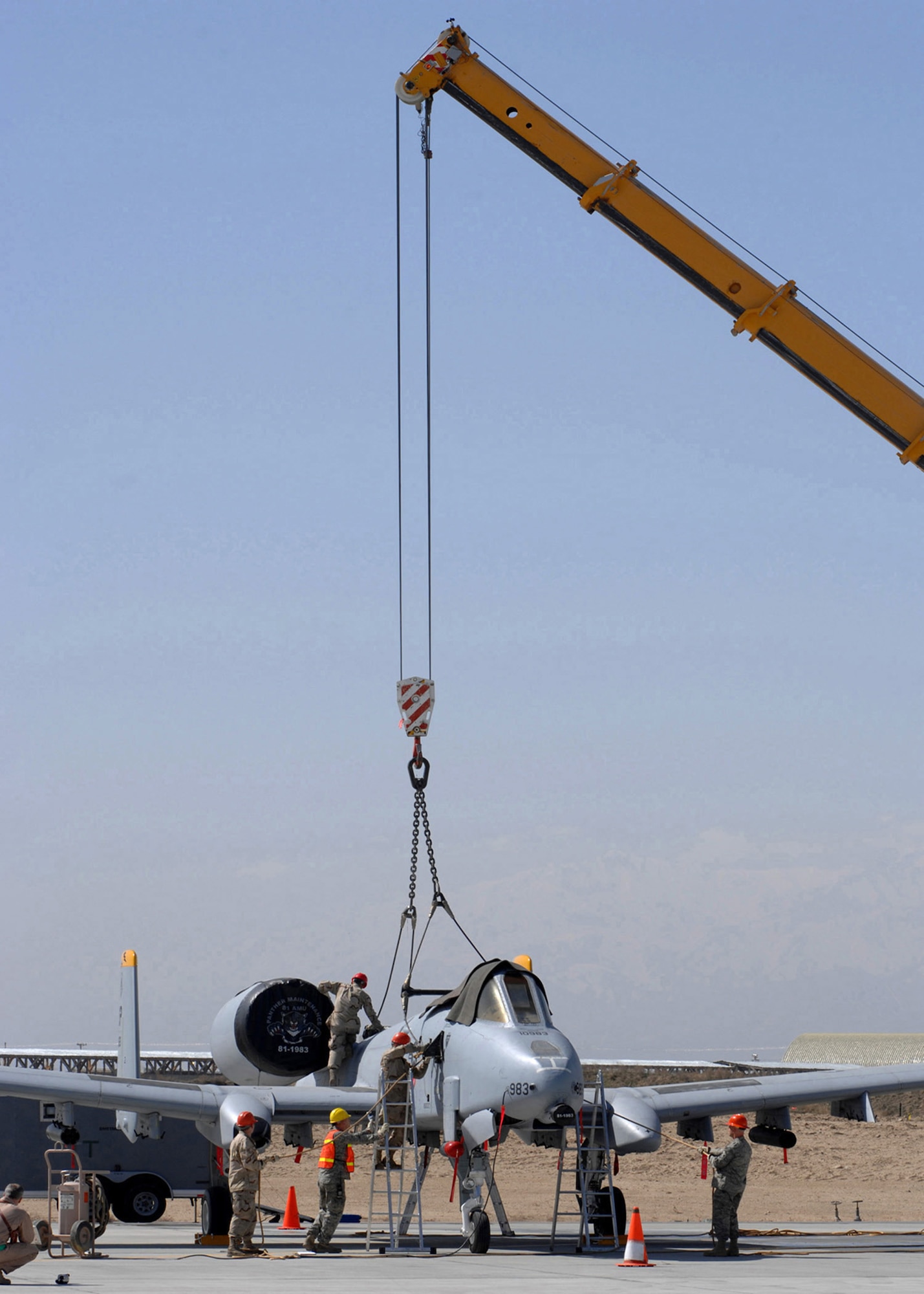 BAGRAM AIR BASE, Afghanistan -- 455th Expeditionary Maintenance Squadron Crash Team Airmen attach a lifting harness to an A-10 Warthog here March 11.  The Airmen were participating in the 455th Air Expeditionary Wing’s first major accident response exercise.  (U.S. Air Force photo by Master Sgt. Demetrius Lester)