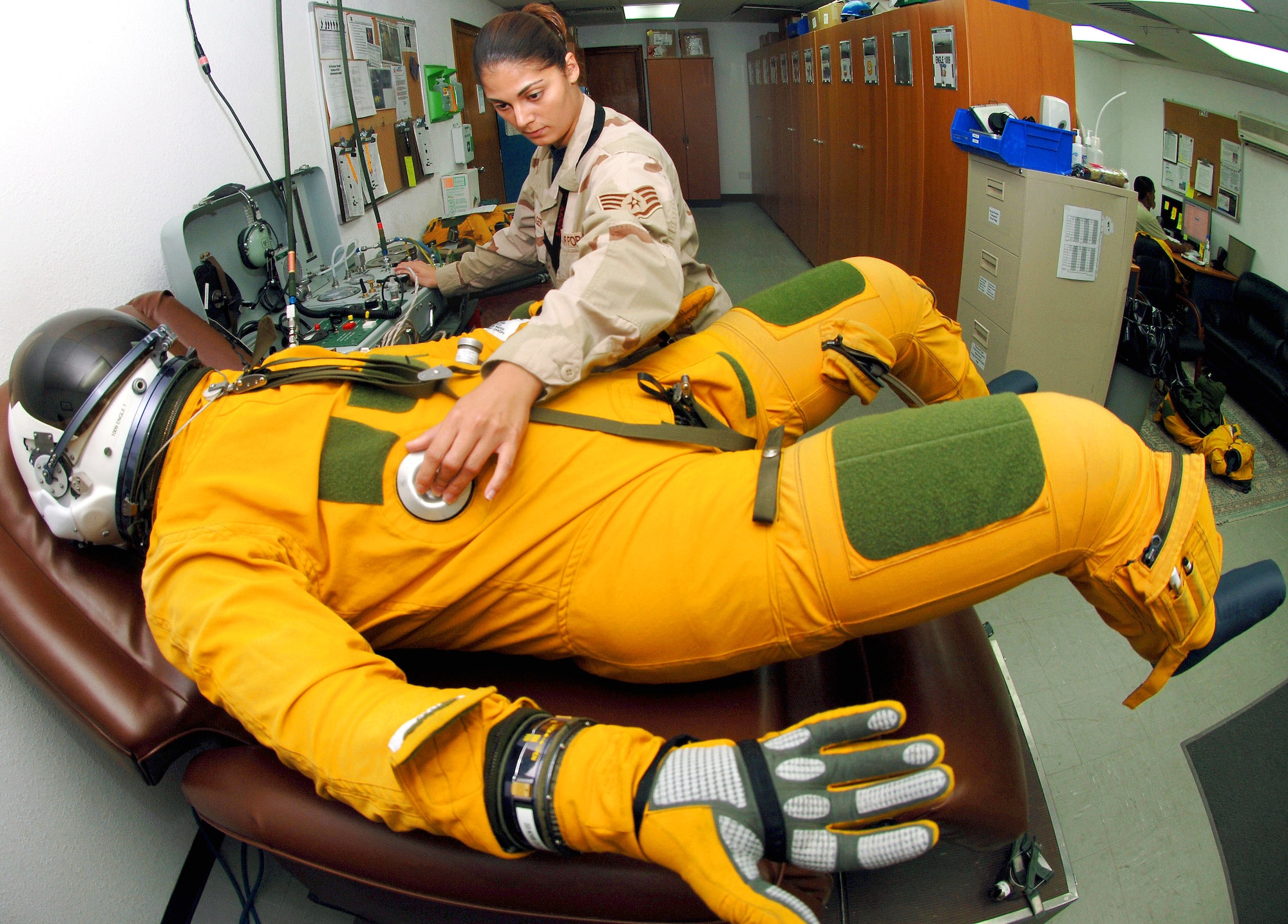 Staff Sgt. Nikolina Kreager, a life support specialist with the 99th Expeditionary Reconnaissance Squadron at an air base in Southwest Asia, ensures a U-2 Dragon Lady pilot is set for the day's mission by checking the flight suit to make sure it can pressurize properly at high altitudes.  (U.S. Air Force photo/Senior Airman Levi Riendeau)