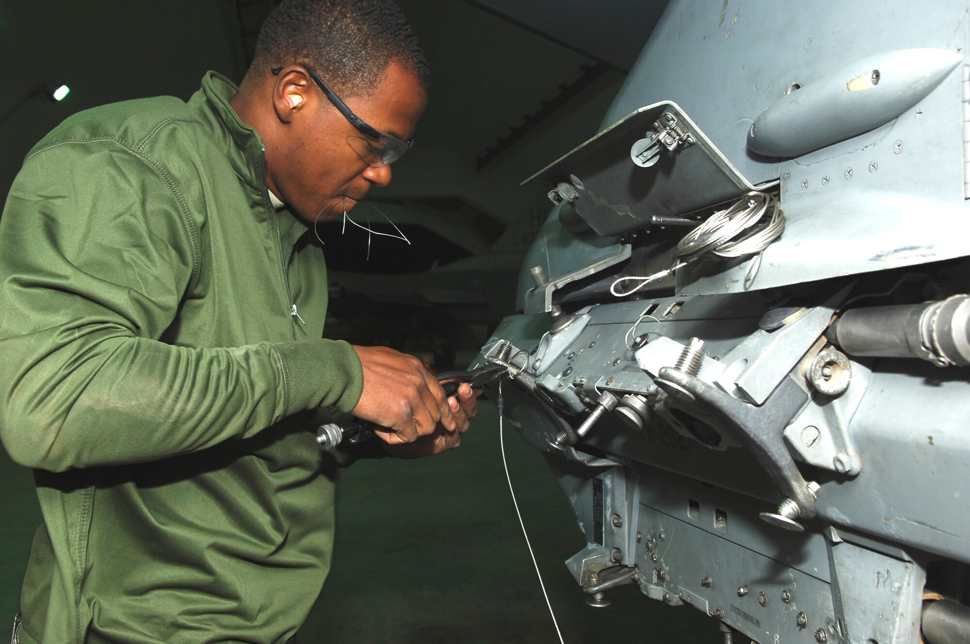 BALAD AIR BASE, Iraq -- Airman 1st Class Ray Williams, 332nd Expeditionary Aircraft Maintenance Squadron Viper Aircraft Maintenance Unit armament systems specialist, prepares alternate mission equipment for bombs to be loaded here, March 13. AME is the way munitions are attached to an aircraft. Airman Williams is deployed from Hill Air Force Base, Utah. (U.S. Air Force photo/ Staff Sgt. Mareshah Haynes)