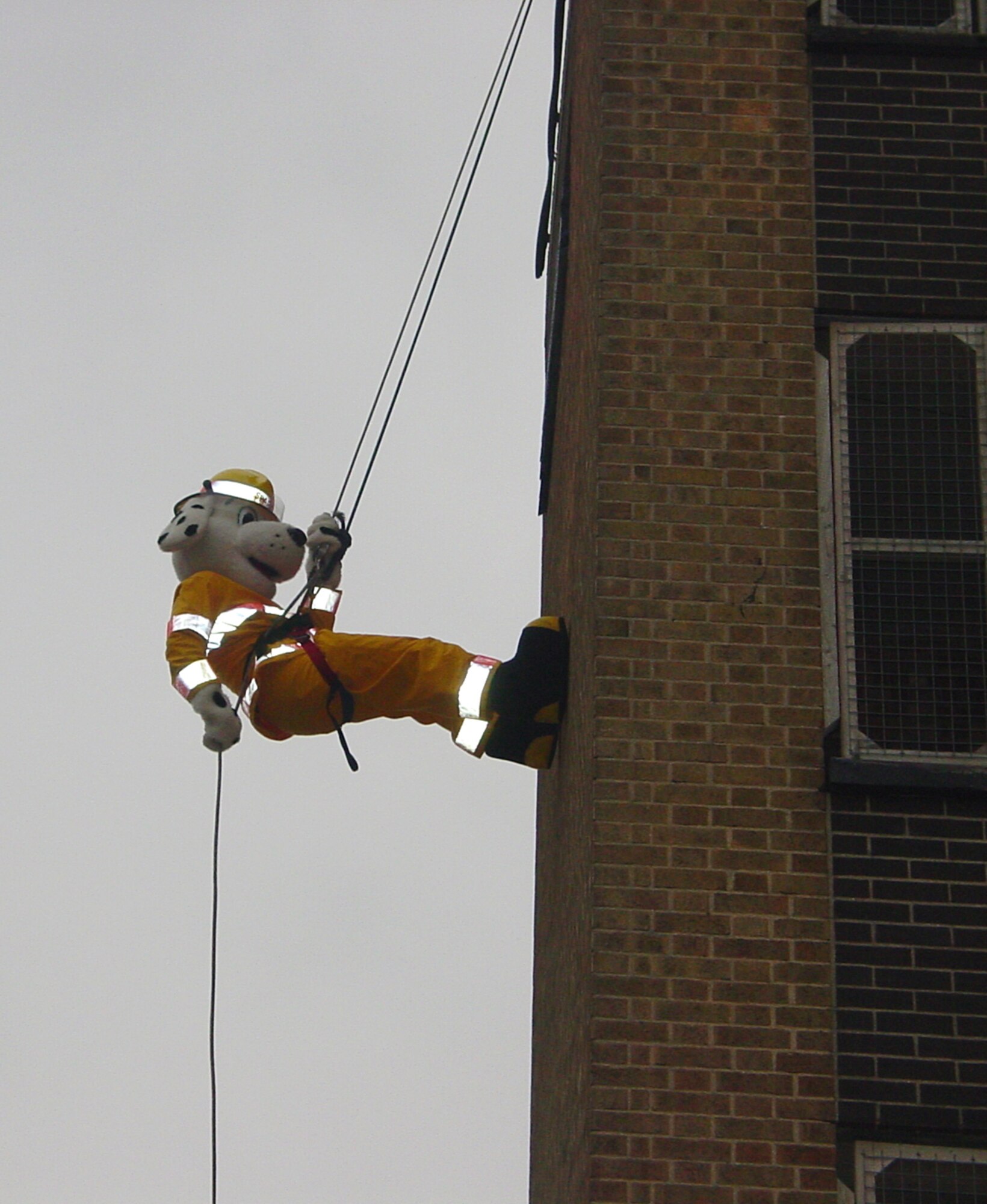 Dressed as Sparky the Fire Dog, Staff Sgt. Sean Katz rappells down the tower at Cambridgeshire Fire Station. Sergeant Katz raised £211.65 for a children's cancer charity. (Courtesy photo)            