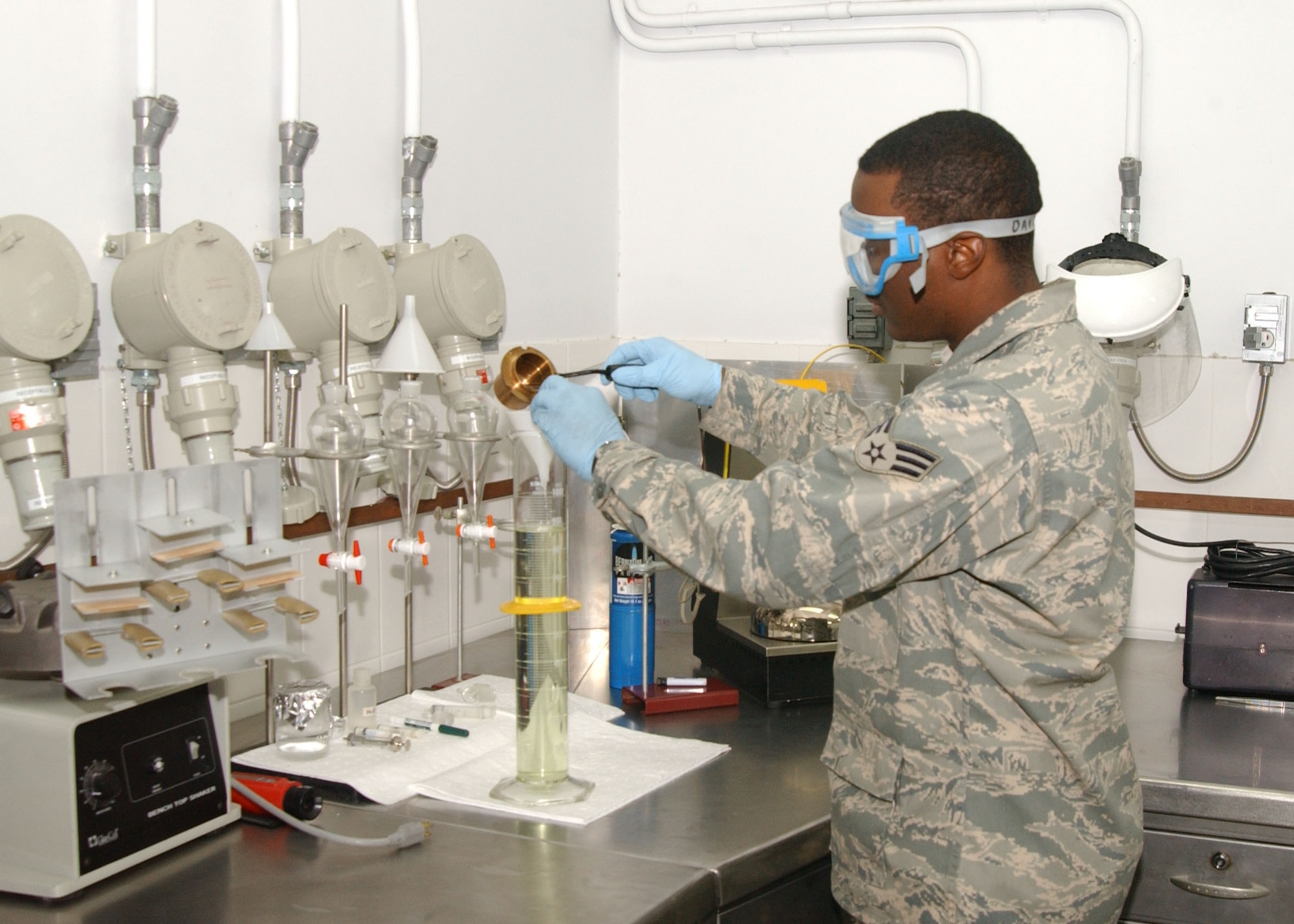 Senior Airman Donald Davis, 39th Logistics Readiness Squadron fuel laboratory technician, pours a fuel sample into a graduated cylinder to test its specific gravity Feb. 20. (U.S. Air Force photo by Tech. Sgt. Patrick Hyde)