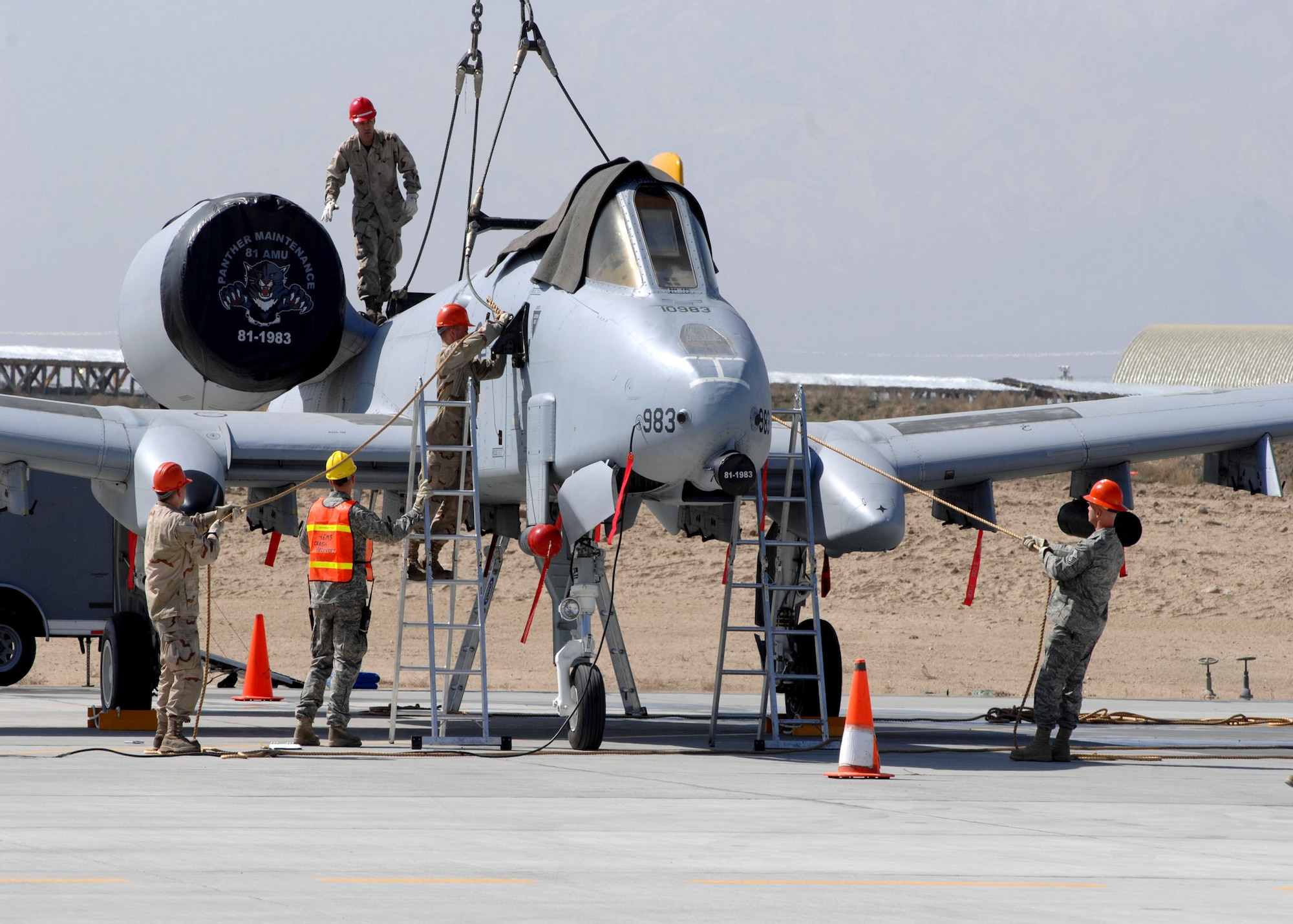 BAGRAM AIR BASE, Afghanistan -- 455th Expeditionary Maintenance Squadron Crash Team Airmen attach a lifting harness to an A-10 Warthog here March 11.  The Airmen were participating in the 455th Air Expeditionary Wing’s first major accident response exercise here.  (U.S. Air Force photo by Master Sgt. Demetrius Lester)