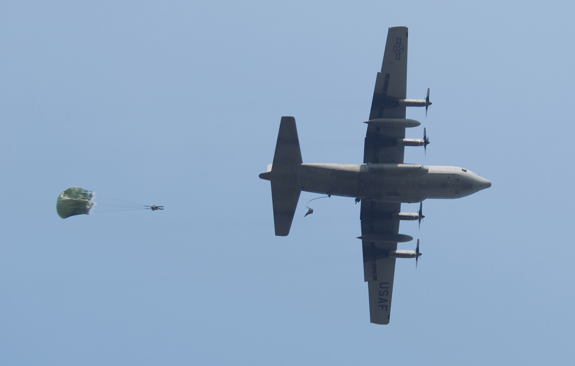 Yokota Air Base, Japan--Airman from the 36th Contingency Response Group, out of Andersen Air Force Base, Guam parachute out of a C-130 Hercules located here on 18 Mar. The Airman of the 36th CRG are a rapid deployable unit capable of providing initial Air Force presence potentially austere forward operation locations. (United States Air Force photo by Senior Airman Brian Kimball) 