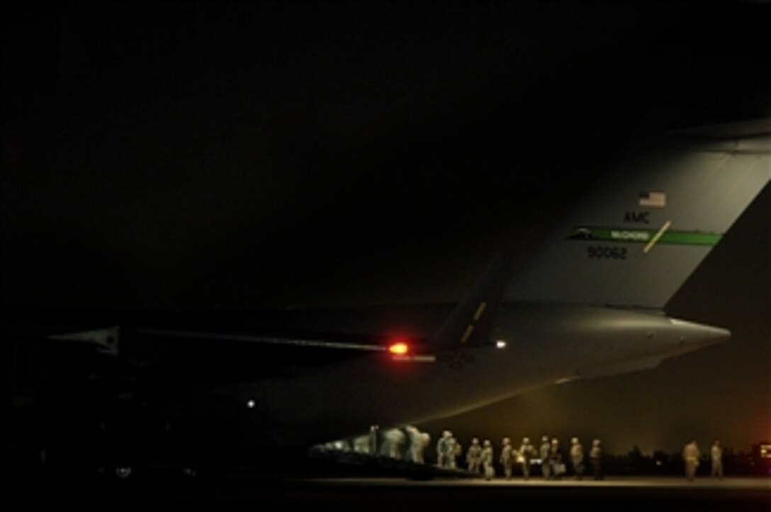 U.S. service members board a U.S. Air Force C-17 Globemaster III aircraft at Sather Air Base, Iraq, on March 12, 2008.  