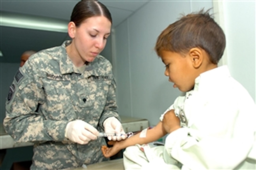 U.S. Army Spc. Monica Brown draws a young boy's blood at the hospital on Forward Operating Base Salerno, Afghanistan, on March 13, 2008.  Brown will be awarded the Silver Star for saving the lives of five wounded soldiers when their convoy came under attack in April 2007.  Brown, a medic from the 782nd Brigade Support Battalion, 4th Brigade Combat Team, 82nd Airborne Division, will be only the second female since World War II to be awarded the Silver Star.  