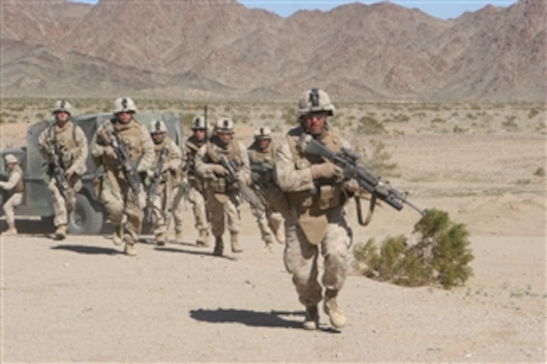 U.S. Marine Corps Sgt. Mendoza, of Echo Company, 2nd Battalion, 7th Marine Regiment, leads fellow Marines during a live-fire village raid exercise on Range 210 at the Marine Corps Air Ground Combat Center in Twenty-nine Palms, Calif., on March 6, 2008. Marines with the unit are participating in Mojave Viper, the Marine Corpsí premiere pre-deployment desert training.  