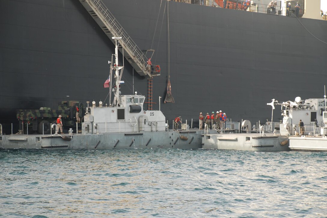 Navy utility boats and the Improved Navy Lighterage System moor off the side of the USNS 2nd LT. JOHN P. BOBO, a maritime prepositioning ship. The vehicles aboard the Bobo will be transfer to the High Speed Vessel Swift, via the INLS, in order for the Marines participating in West African Training Cruise 2008 to conduct a humanitarian assistance mission in Monrovia, Liberia.