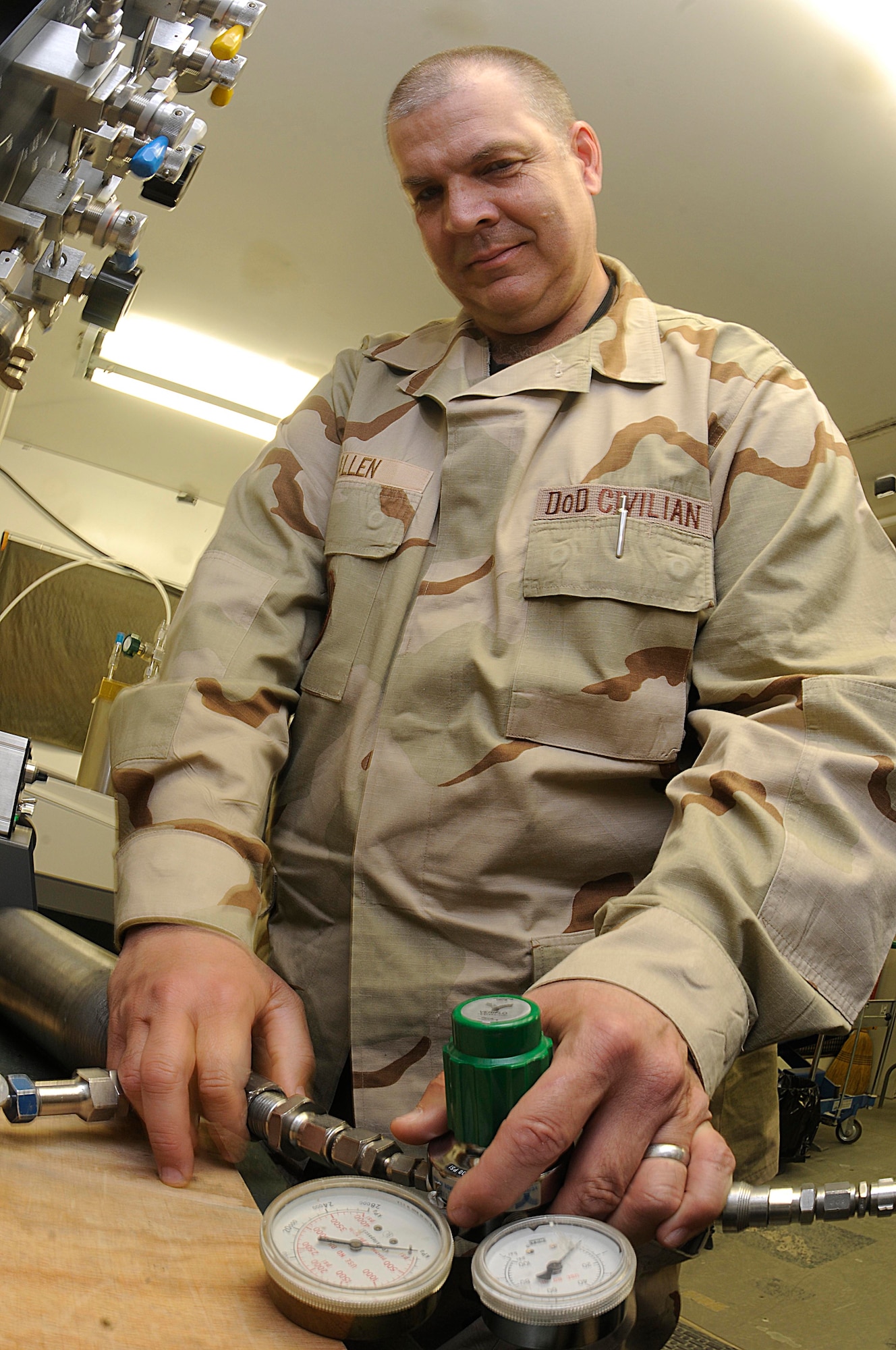 Allen Jeffrey uses a manifold to transfer Aviator’s Breathing Oxygen from a sample cylinder to an oxygen analyzer. (U.S. Air Force photo/Senior Airman Domonique Simmons)
