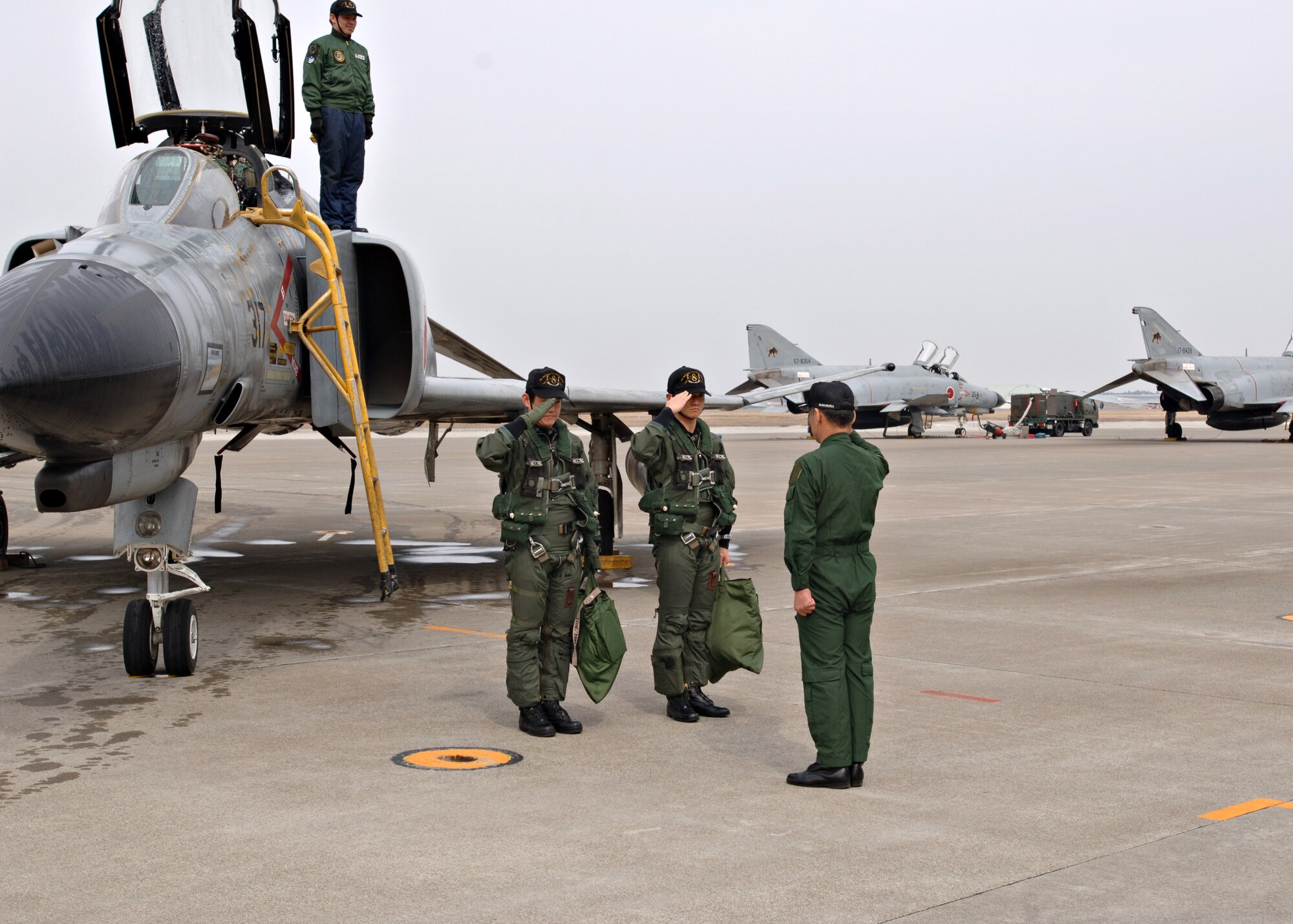 MISAWA AIR BASE, Japan -- Japan Air Self Defense Force Capt.
Yutaka Yamamoto and 1st Lt. Youhei Kubota salute 8th Fighter Squadron
commander Lt. Col. Yoshihide Nunomura on March 19, 2008. The salute
followed the final flight of the decommissioned F-4. This F-4 was the
first to be decommissioned at Misawa AB. (U.S. Air Force photo by Airman 1st Class Christopher Bevins)