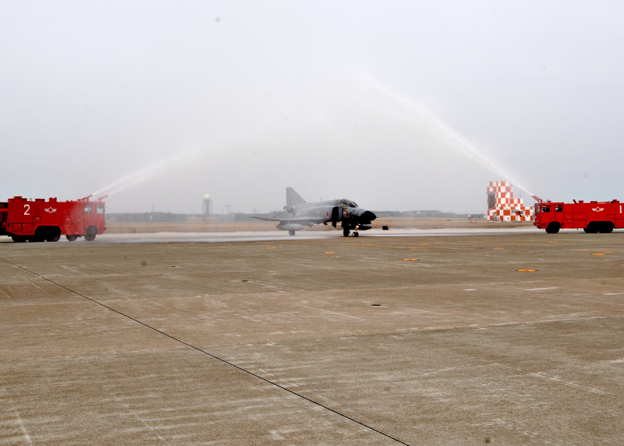 MISAWA AIR BASE, Japan -- A Japan Air Self Defense Force F-4 Falcon is hosed down after its final active flight on March 19, 2008.  The aircraft, piloted by Capt. Yutaka Yamamoto and 1st Lt. Youhei Kubota, was the first F-4 to be decommissioned at Misawa AB. (U.S. Air Force photo by Airman 1st Class Christopher Bevins)