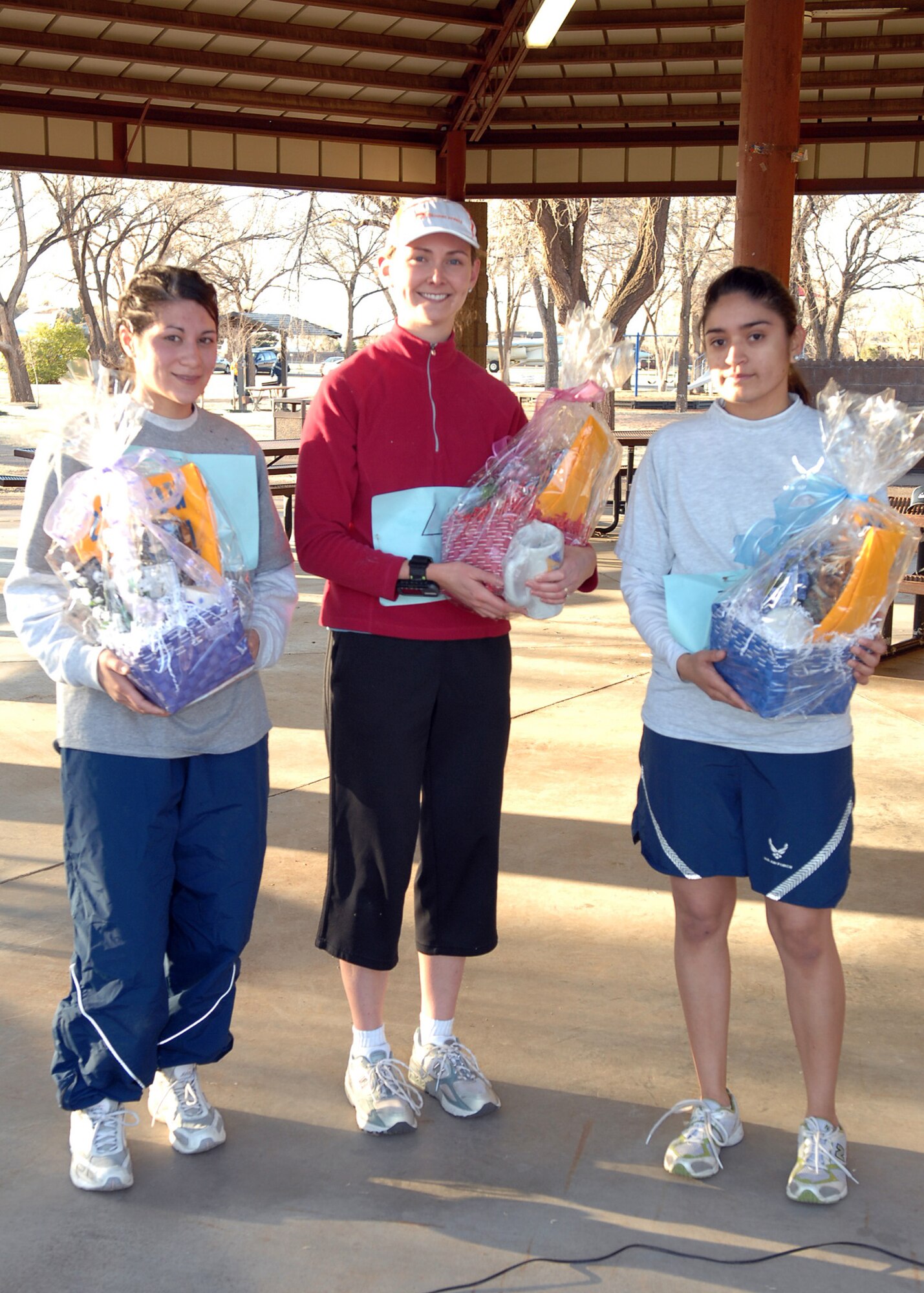 CANNON AIR FORCE BASE, N.M. - From left to right, Airman 1st Class Breanna Page, 27th Special Operations Aeromedical Squadron, Ms. Elizabeth Roberts, and Airman 1st Class Evelyn Chavez, 27th Special Operations Wing, display their prizes as top finishers  in the Women's History Month Fitness Challenge on March 21 at Unity Park. Ms Roberts came in first place with a time of 24 minutes, Airman Chavez finished second with a  time of 25:13, and Aiman Page finished third at 26:06. (U.S. Air Force photo by Airman Basic Danielle Martin)
