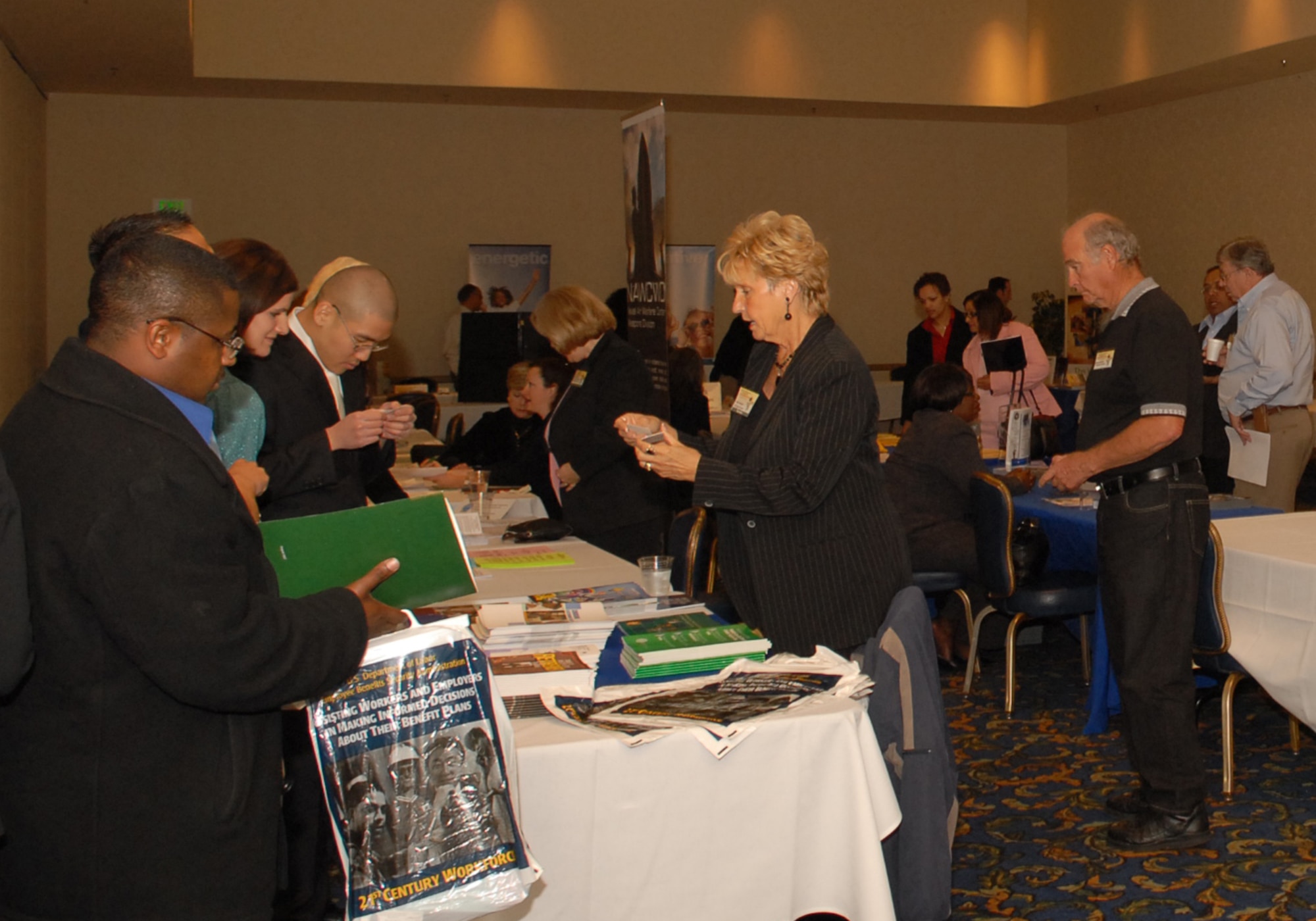 VANDENBERG AIR FORCE BASE, Calif. --  Team V members peruse information tables at the the ‘Grow Your Business’ conference in the Pacific Coast Club, which took place March 19 and 20.The two-day conference gave business owners opportunities to meet and market with government purchase card holders and to network with federal agencies, prime contractors and other small businesses. (U.S. Air Force photo/Airman 1st Class Stephanie Longoria)