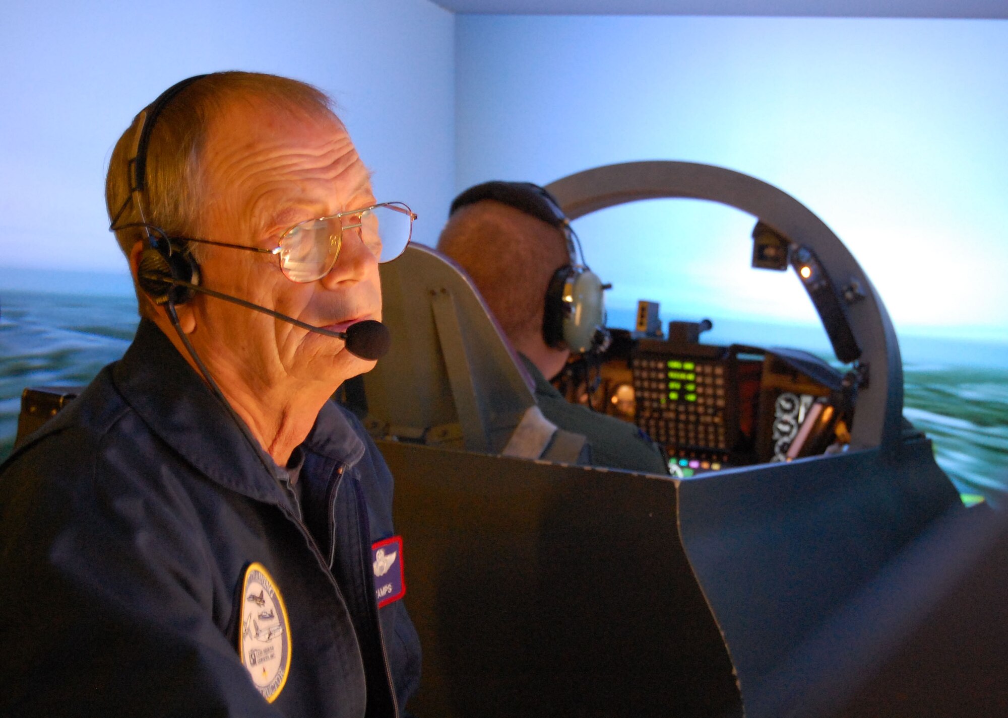 LAUGHLIN AIR FORCE BASE, Texas – Gene Stamps, T-38 contract simulator instructor, observes a Specialized Undergraduate Pilot Training student during a practice flight in the T-38 simulator here March 24. Pilots spend countless hours in the simulators prior to flying Laughlin’s training jets practicing everything such as runway approaches, emergency procedures and tower communications. (U.S. Air Force photo by Airman 1st Class Sara Csurilla)