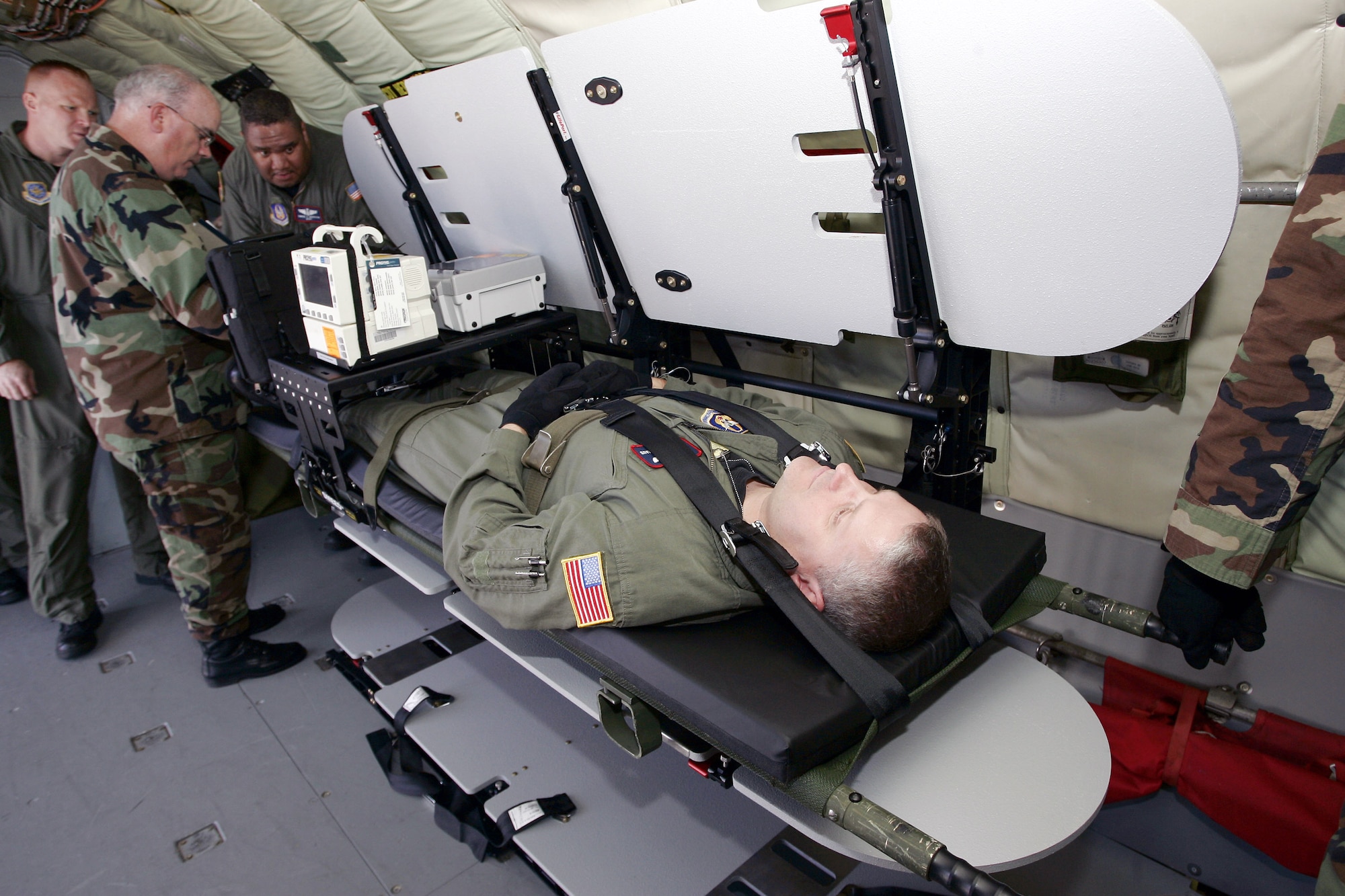 A KC-135 Stratotanker aircrew member lays on a stacking litter system as part of a demonstration for the system by the Air Mobility Battlelab June 22 at McGuire Air Force Base, N.J. The aircrew member is from the 108th Air Refueling Wing at McGuire AFB. The Air Mobility Battlelab is located in the U.S. Air Force Expeditionary Center on Fort Dix, N.J. (U.S. Air Force photo/Master Sgt. Bob Lorusso) 