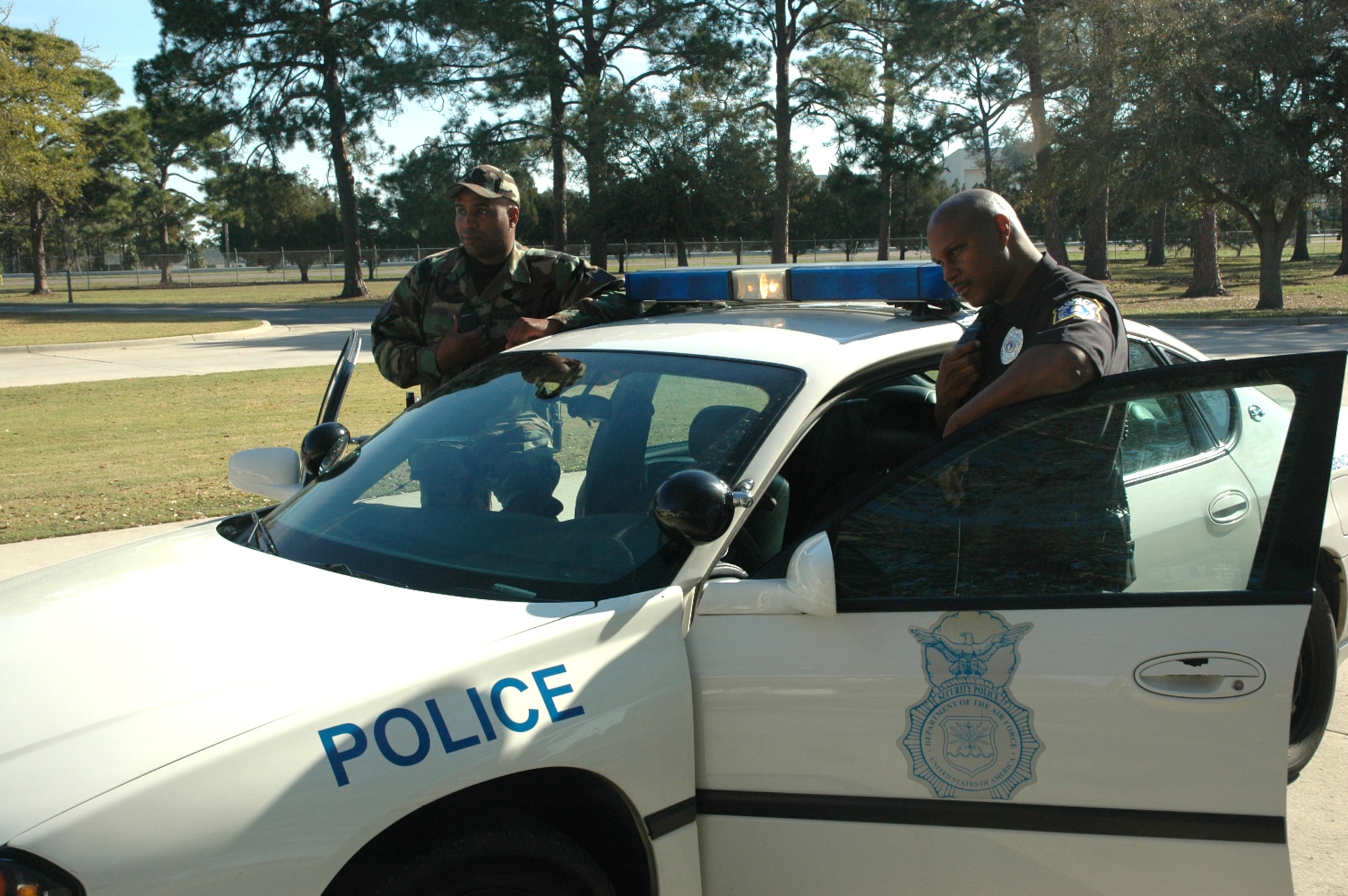 Staff Sgt. James A. Dandridge Jr. (left) and Patrolman Duane Coleman (right) patrol Tyndall Air Force Base as rotated partners. Sergeant Dandridge, a national guardsman, has been at Tyndall for two years and Patrolman Coleman has been working as an AF police officer here since February.
